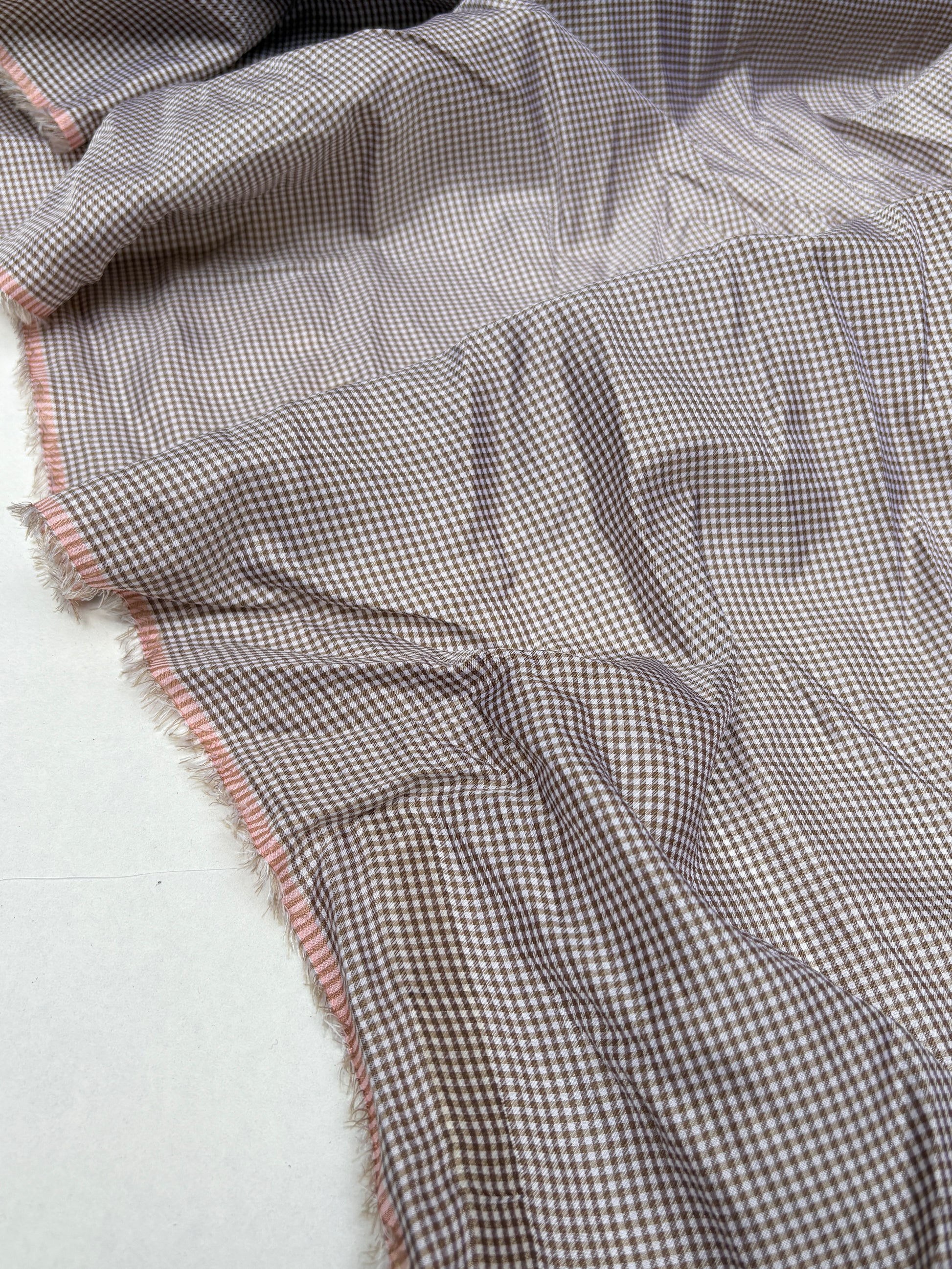 Thin patterned fabric is shown in multiple folded views