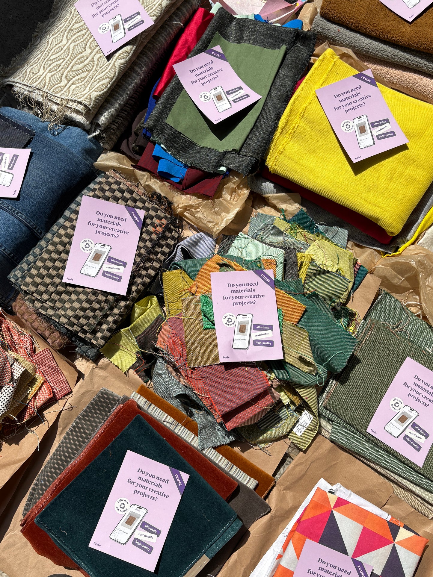 Collection of fabrics in various colors with labels on a table - all ready to inspire creative DIY projects