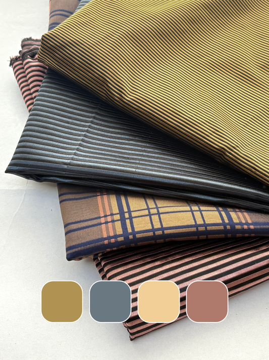 Stack of silk fabric in brown, gray, and plaid patterns with colour swatches below.