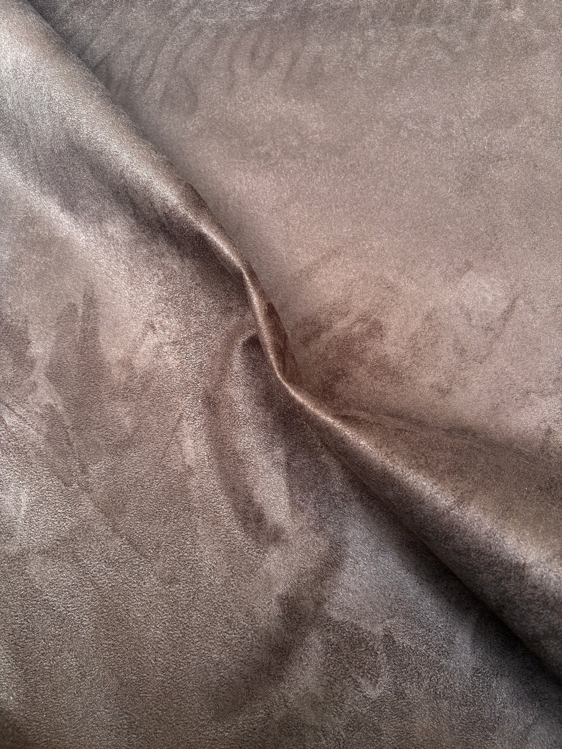 Brown fabric with a suede-like surface is shown hanging flat