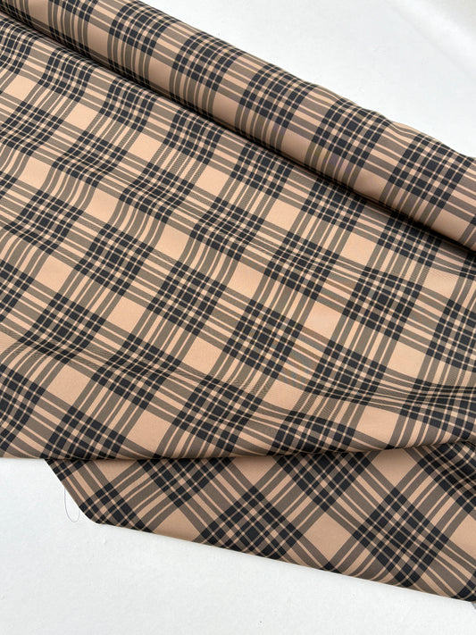 End-of-roll fabric with a tartan-like pattern in close-up.