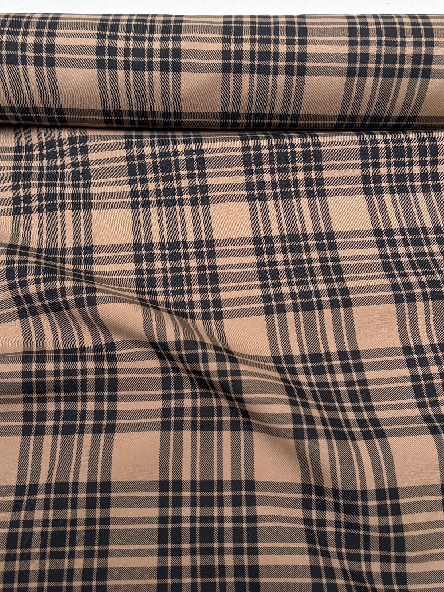 Tartan-like patterned fabric shown in a close end-of-roll view.