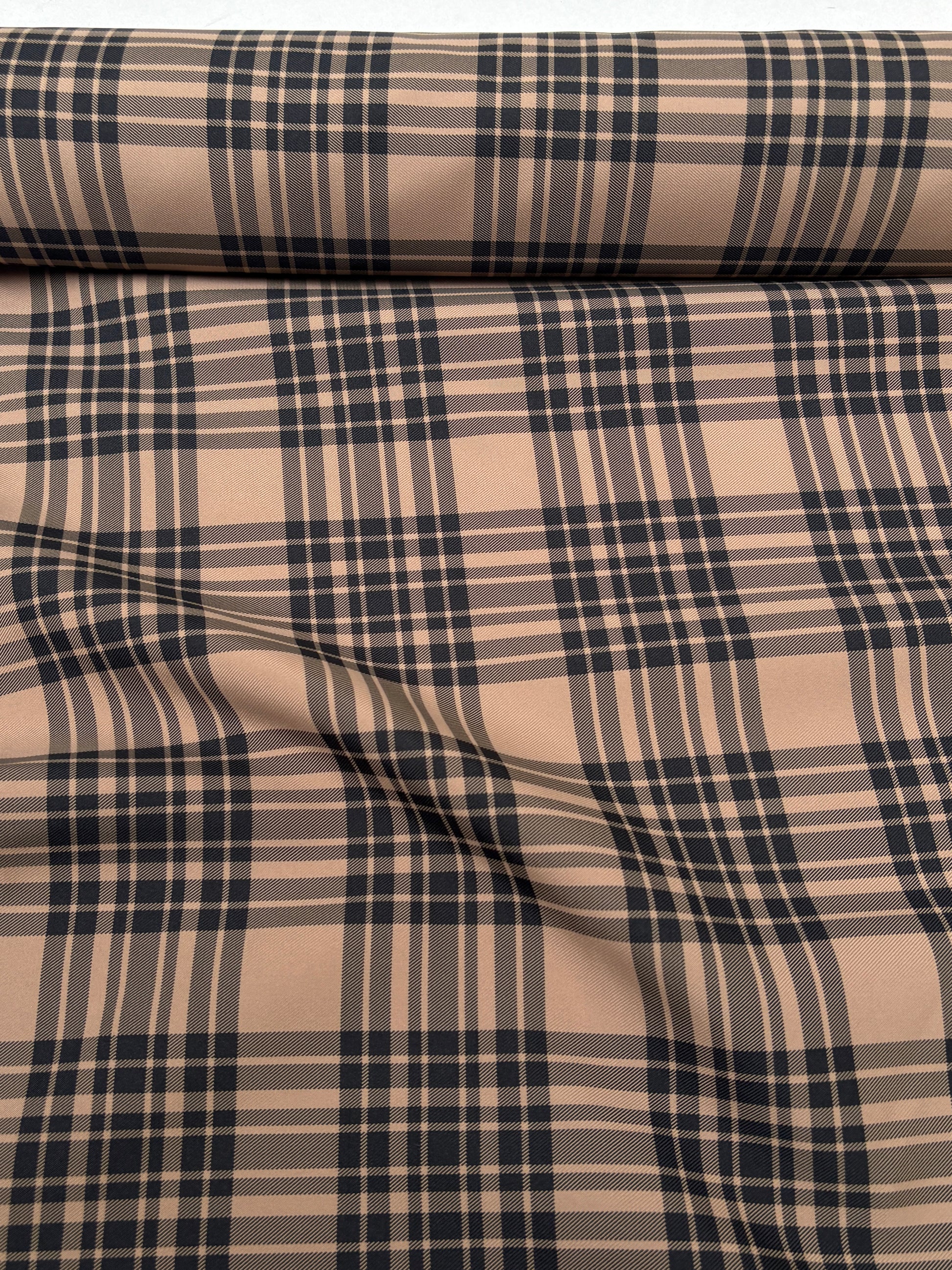 Tartan-like patterned fabric shown in a close end-of-roll view.