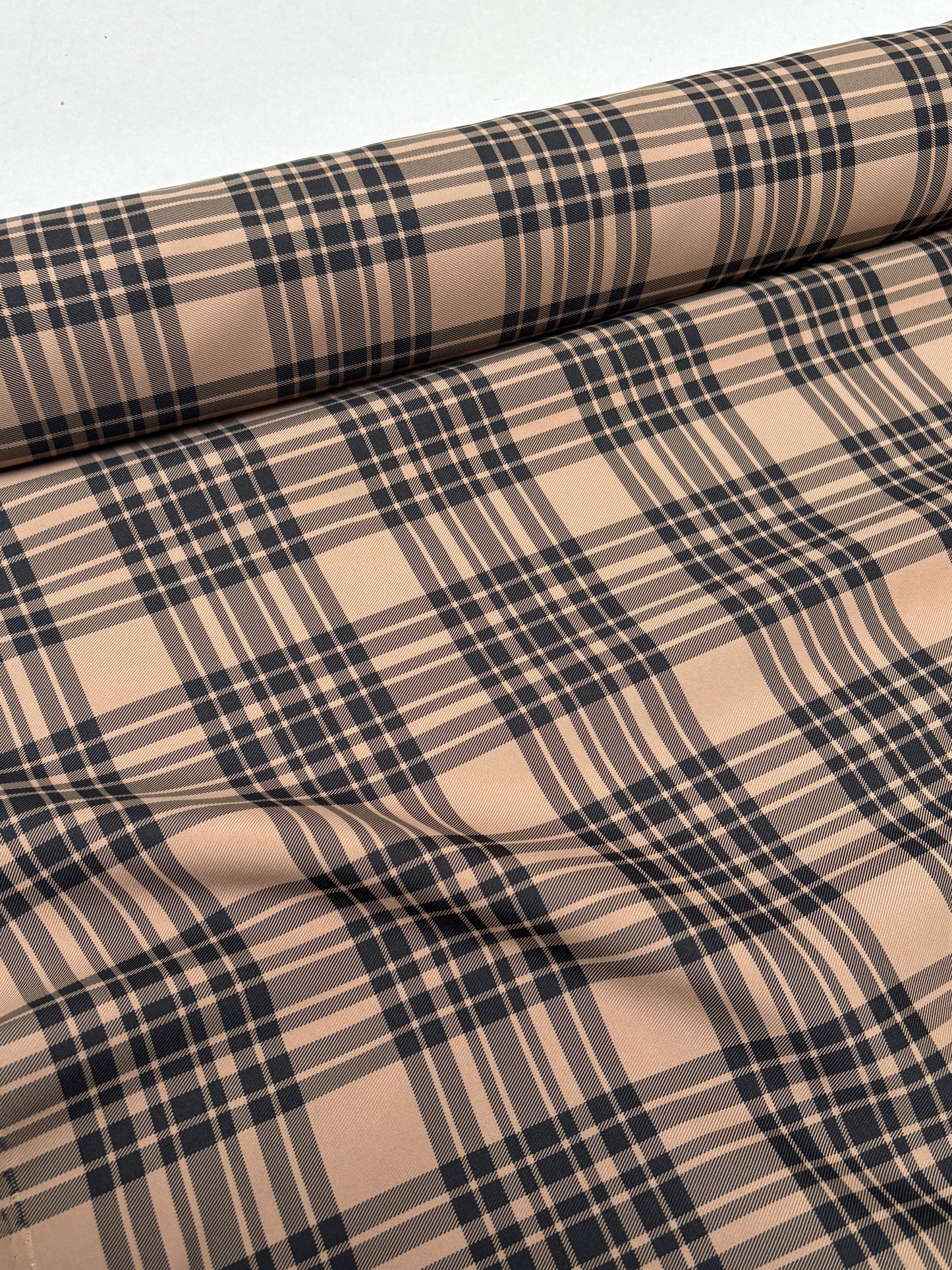 Patterned fabric with a tartan-like look shown in close detail.