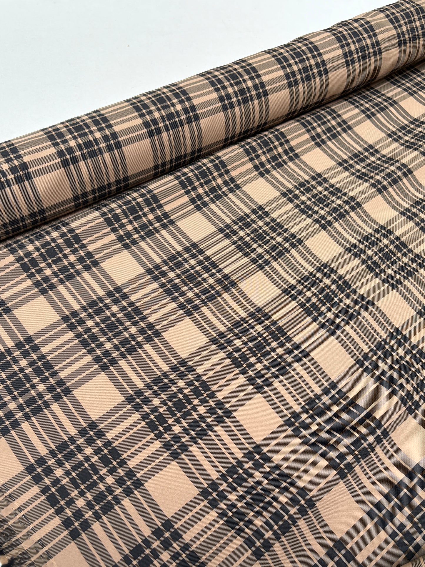 End-of-roll view of fabric with a tartan-inspired checked pattern.