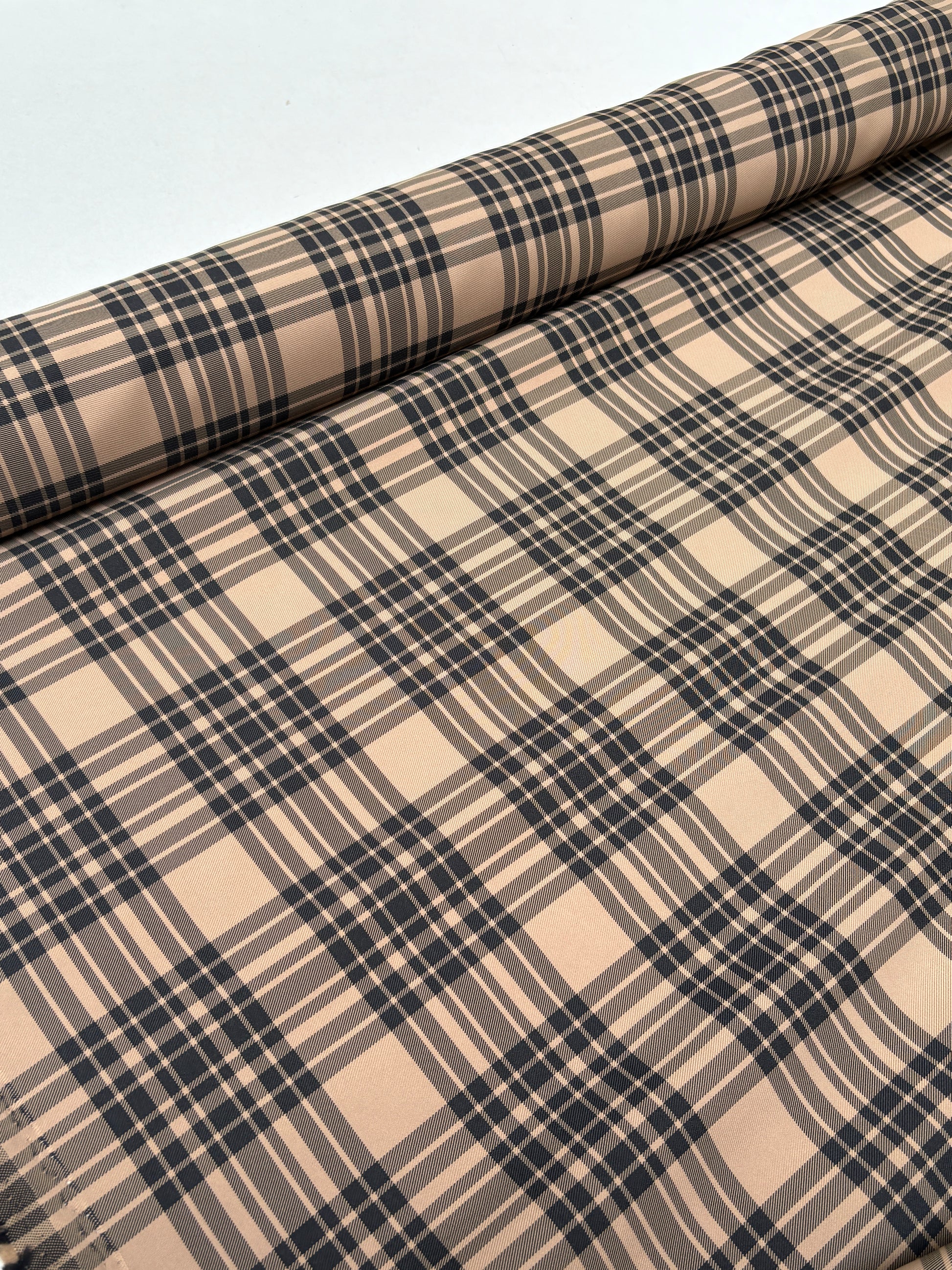 End-of-roll view of fabric with a tartan-inspired checked pattern.