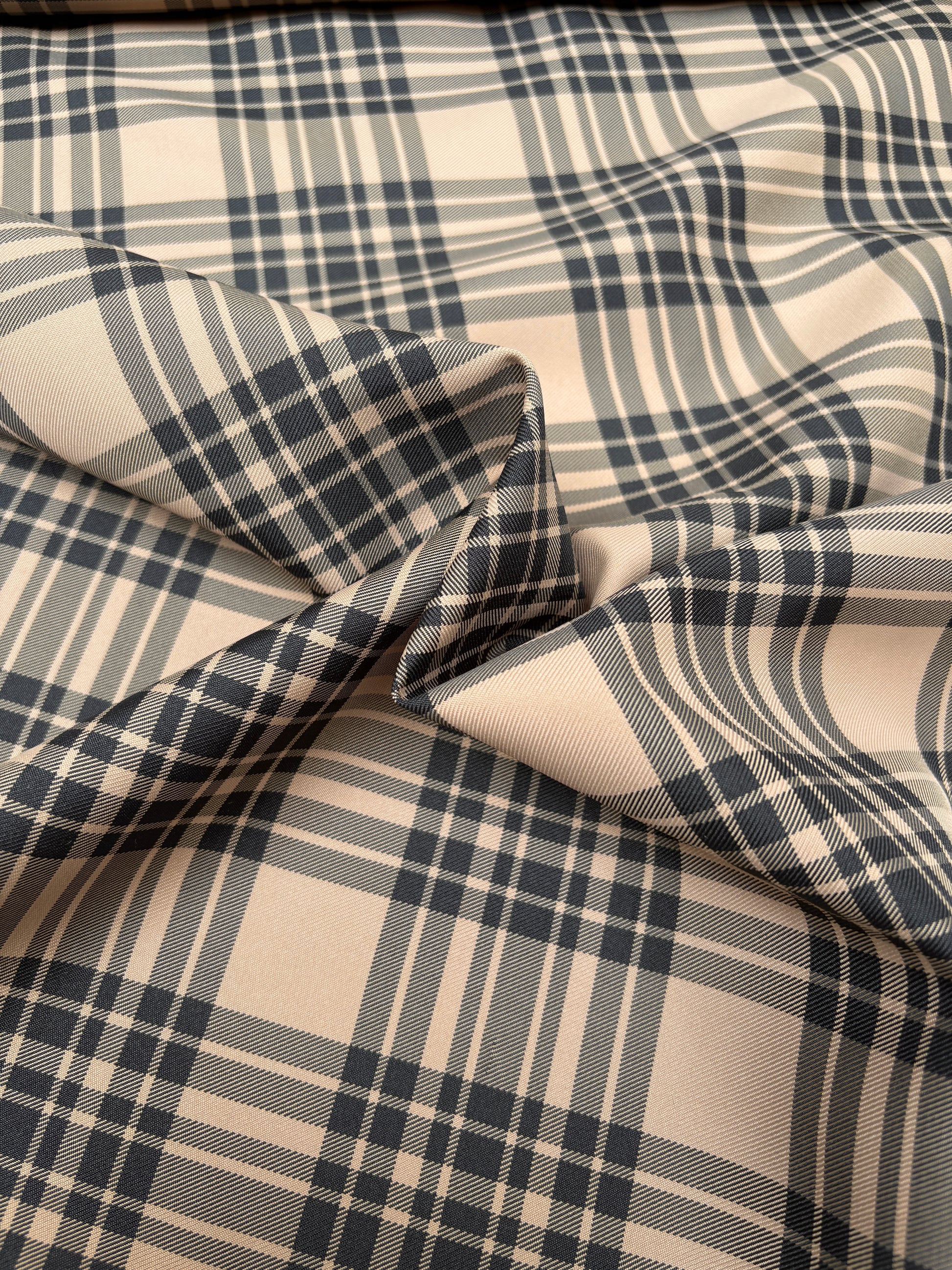 Detailed end-of-roll shot of tartan-like patterned fabric.