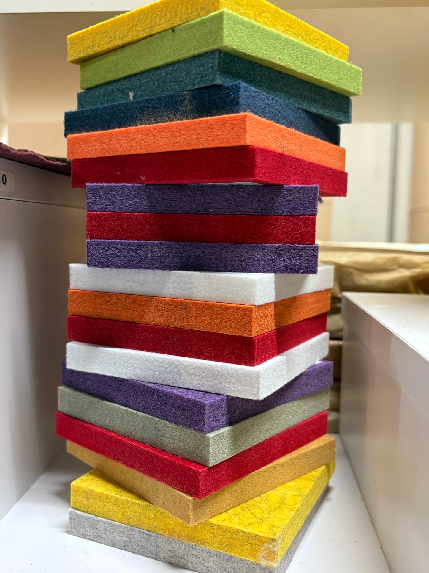Felt tile samples are shown in upright stacks and grouped views