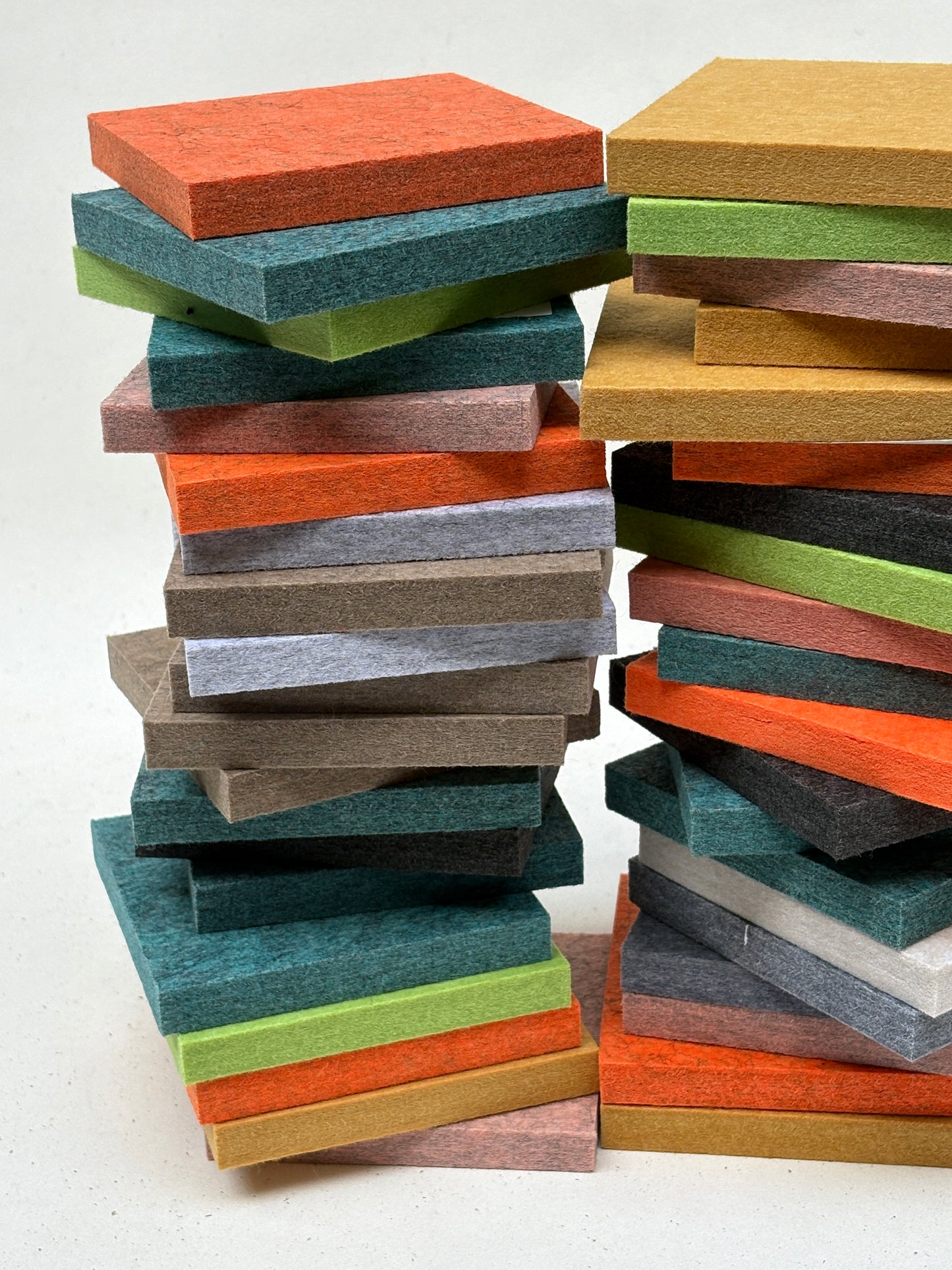 Mixed-colour felt squares are displayed in stacked and close-up arrangements