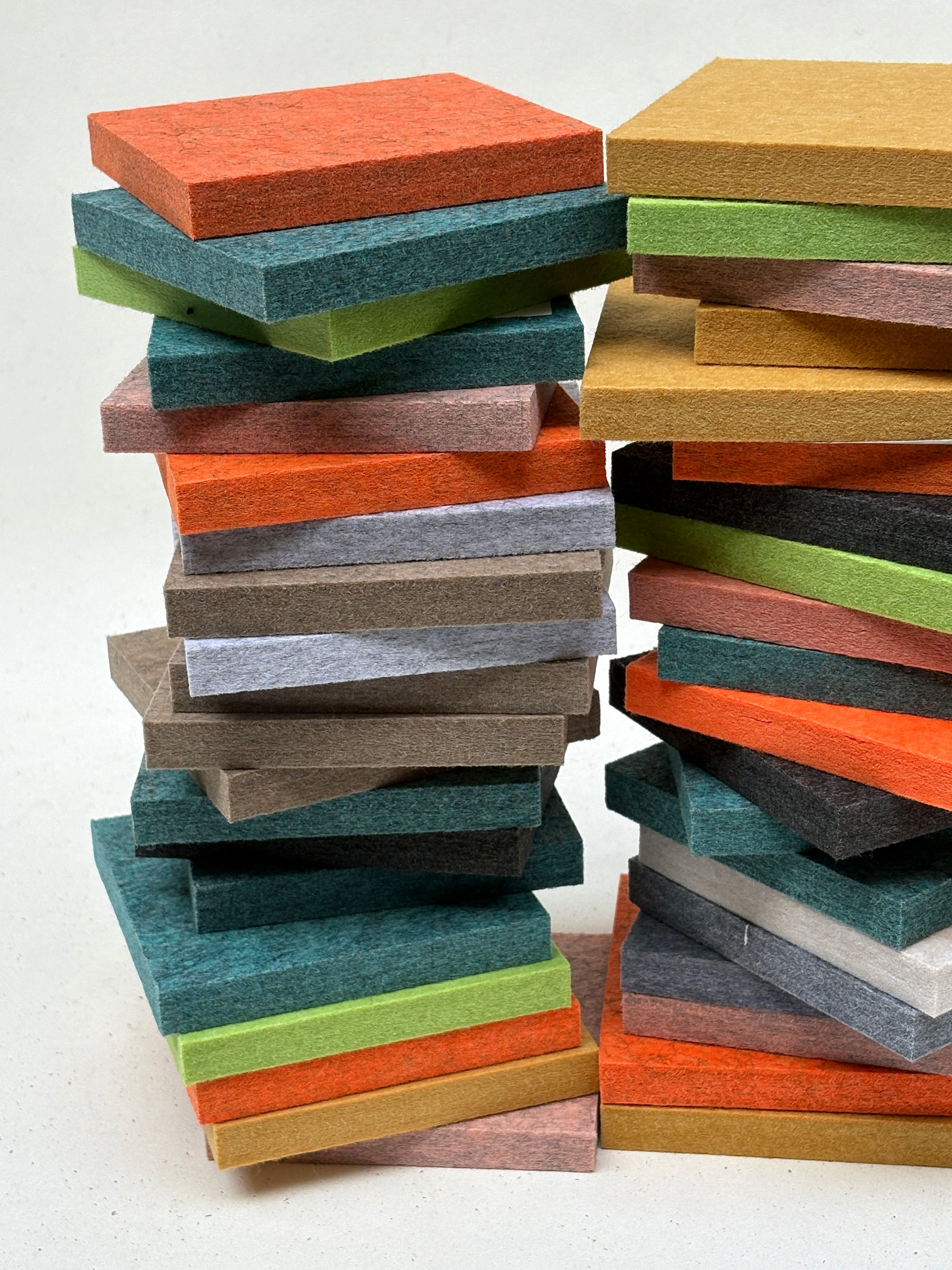 Mixed-colour felt squares are displayed in stacked and close-up arrangements