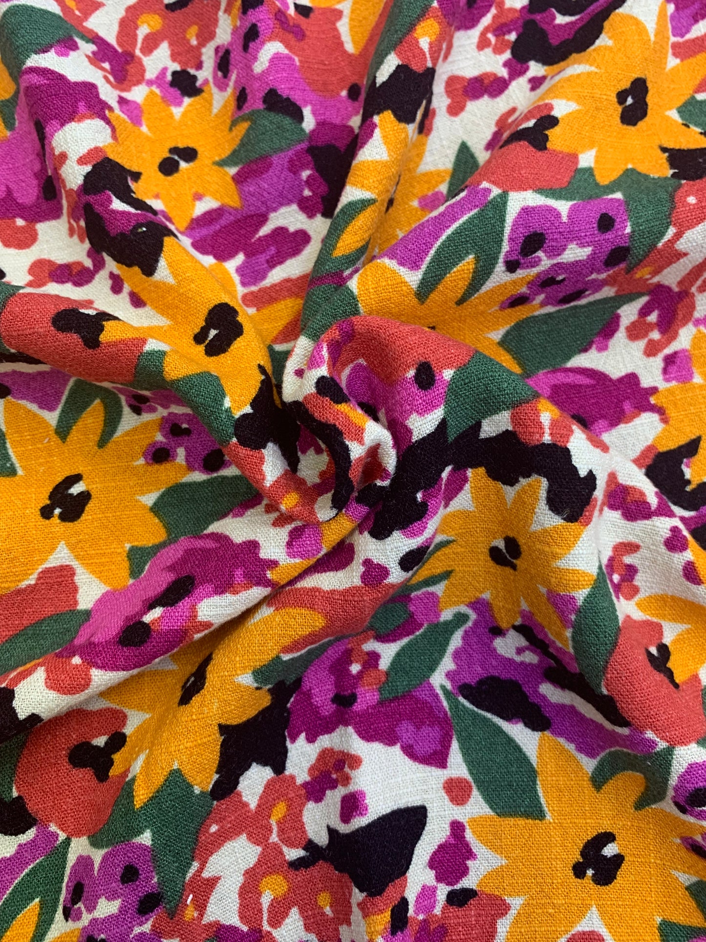 Colourful floral fabric is gathered into a central fold