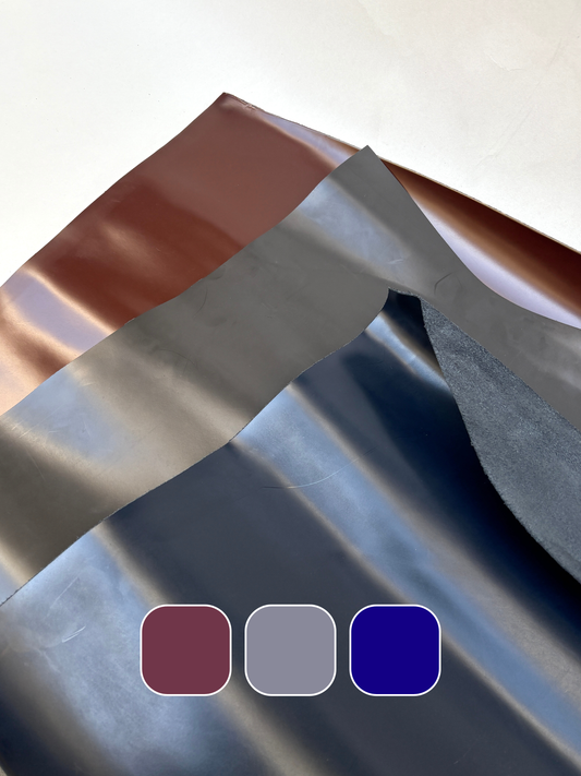     Black, grey, and navy sheet materials are layered in folded stacks