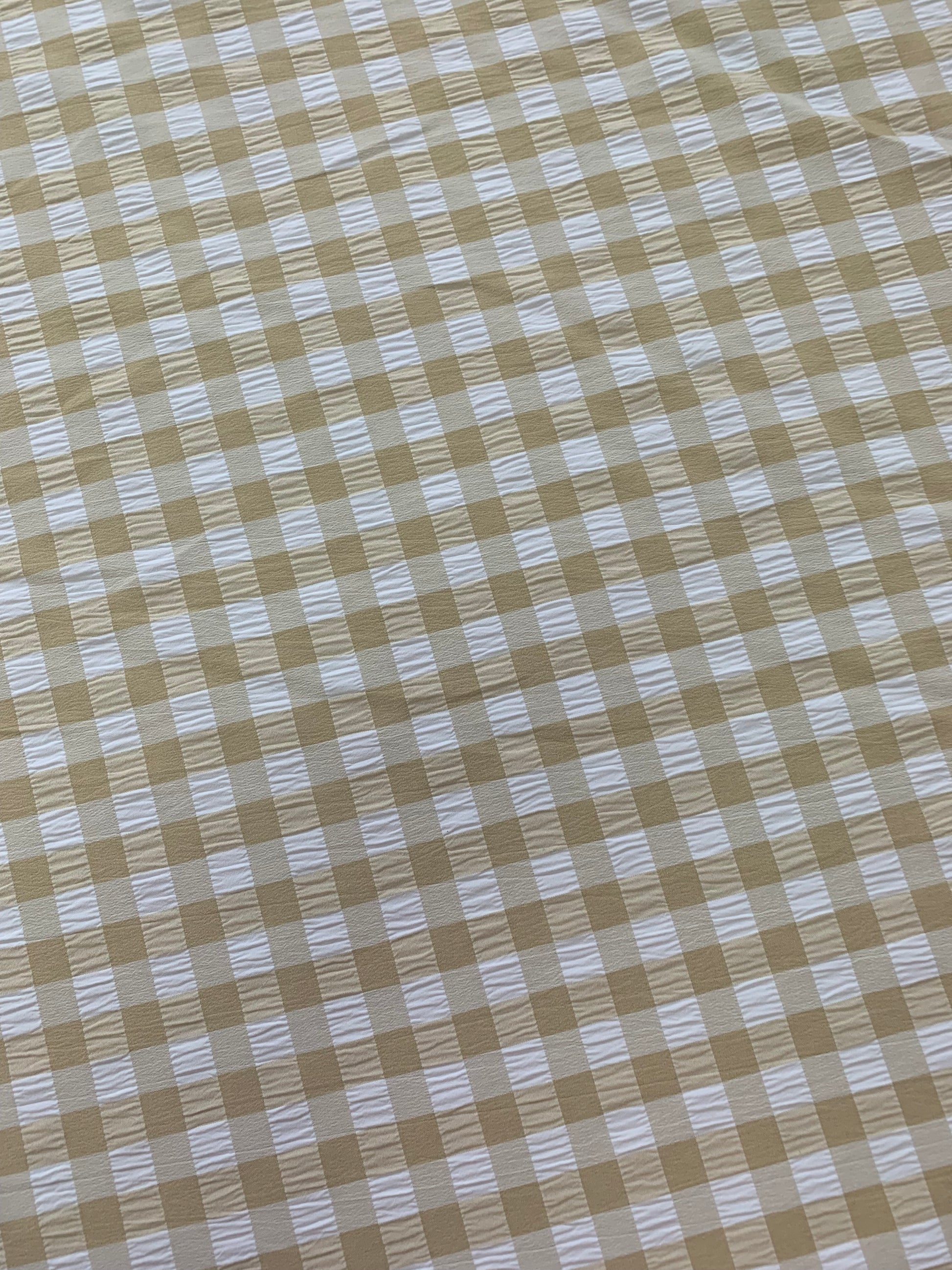 Beige gingham fabric fills the image