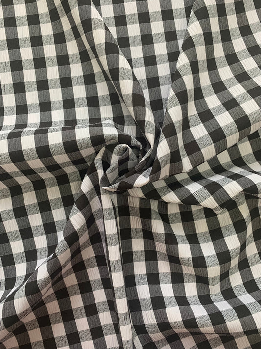 white and black checked fabric is gathered into soft folds.