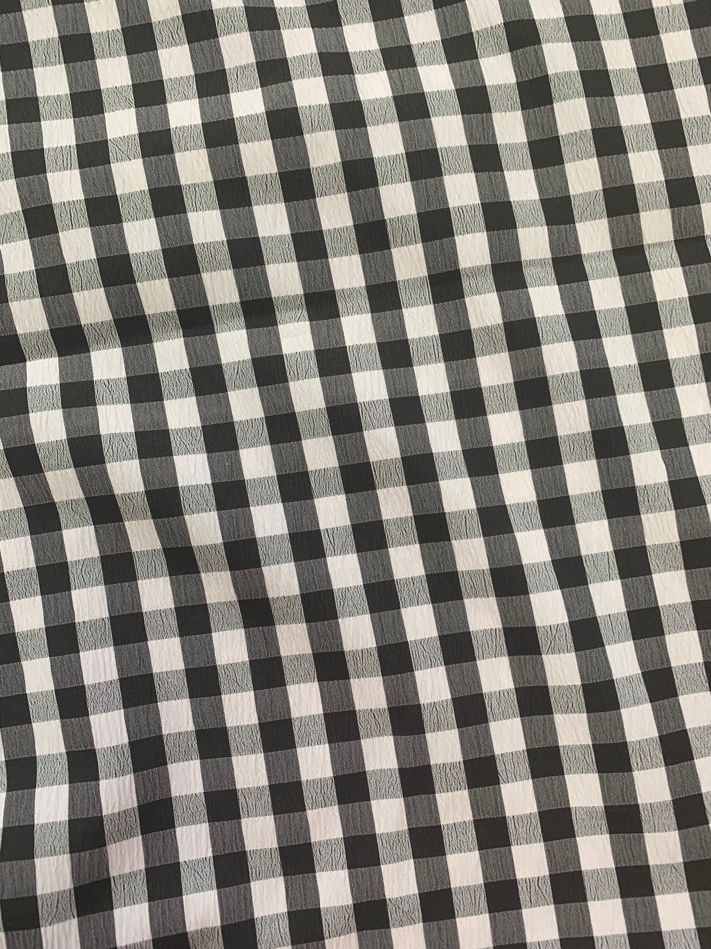 Black and white checked fabric laid flat to show the pattern.