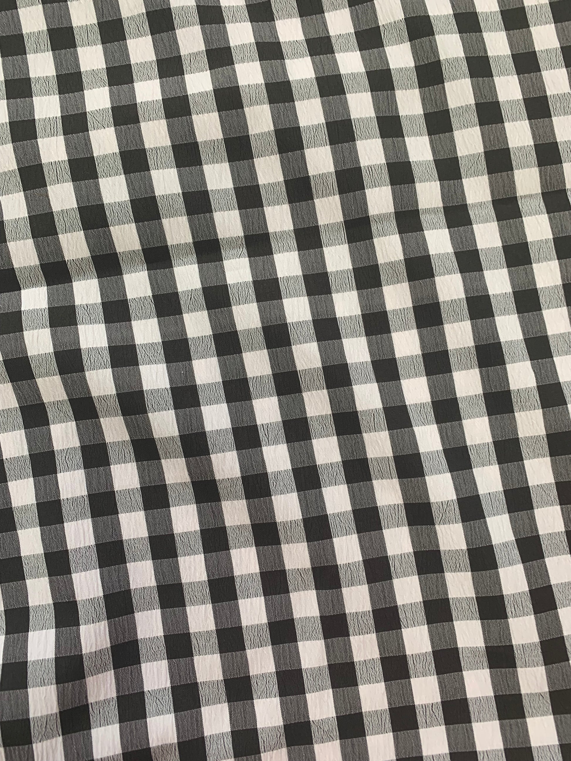 Black and white checked fabric laid flat to show the pattern.