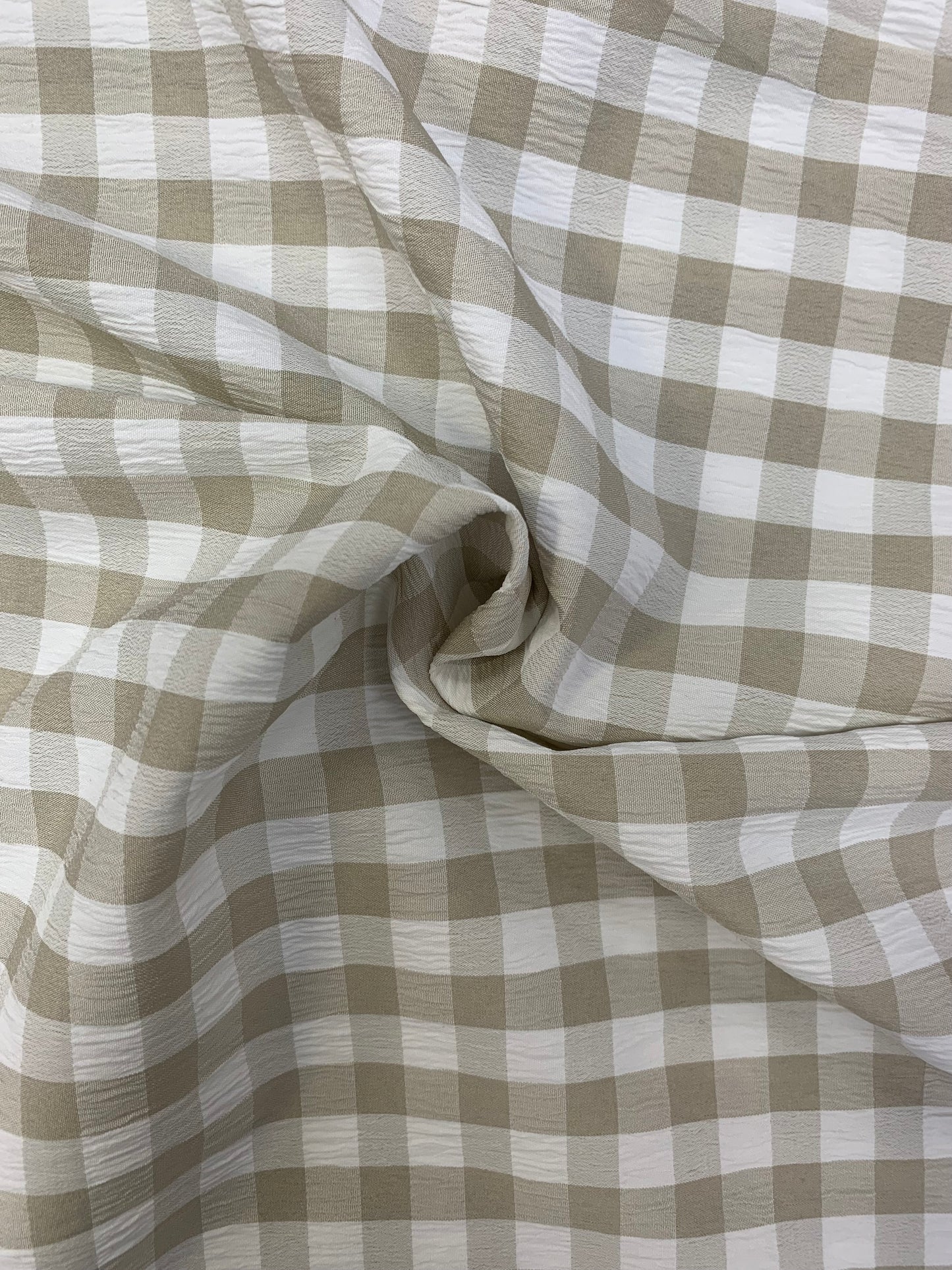 Grey and White checked fabric is gathered into soft folds