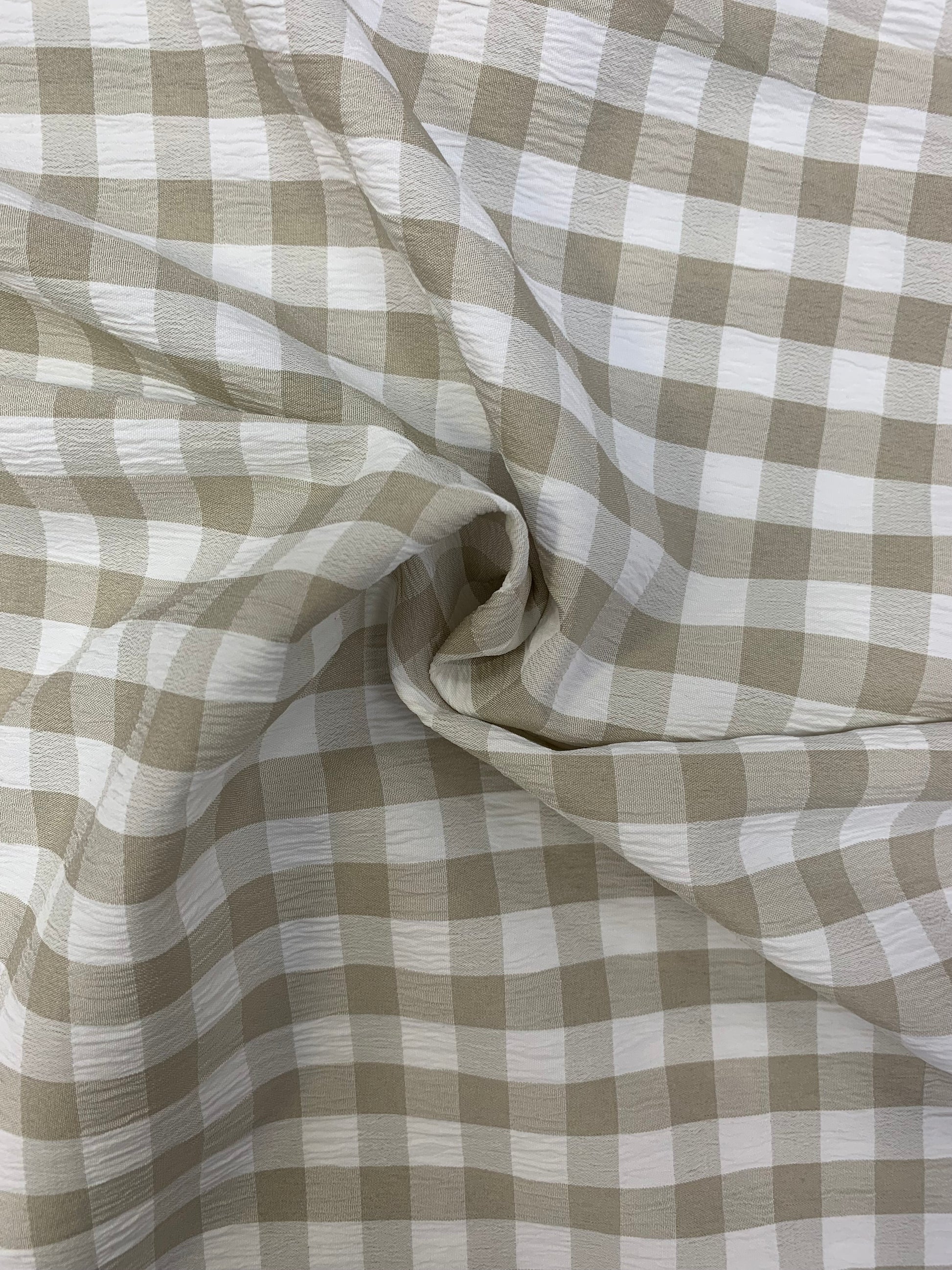 Grey and White checked fabric is gathered into soft folds