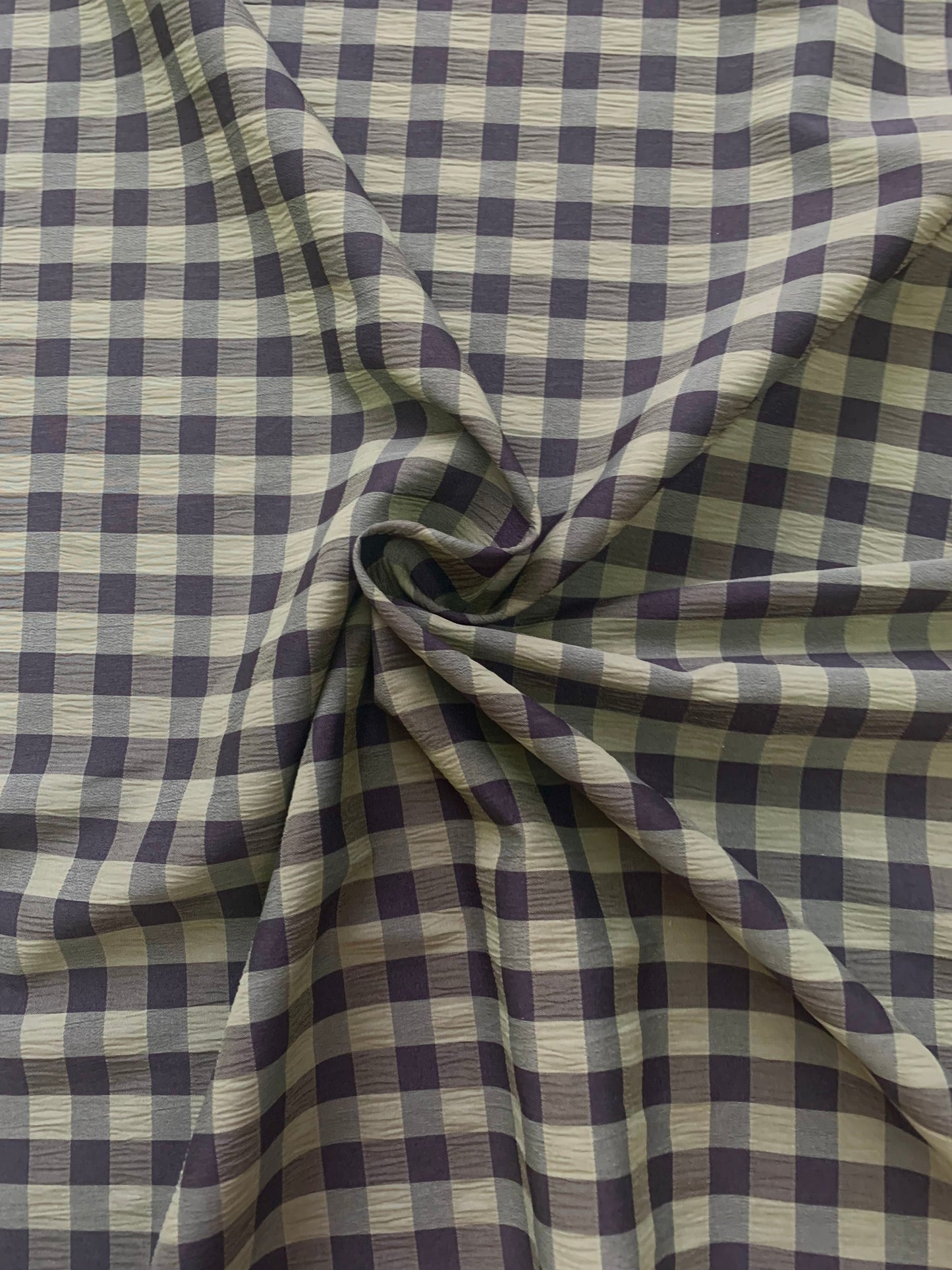 Olive and black checked fabric is gathered into soft folds