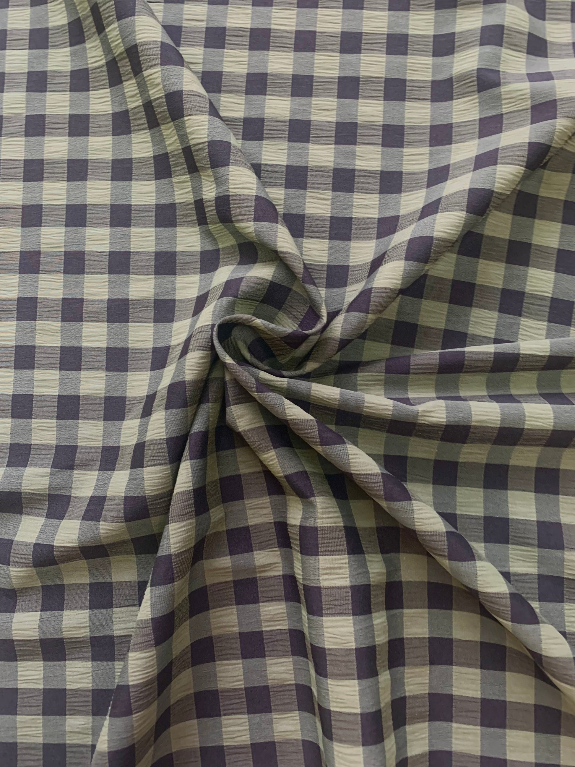 Olive and black checked fabric is gathered into soft folds