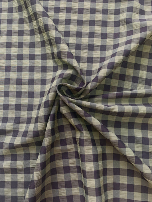 Olive and black checked fabric is gathered into soft folds
