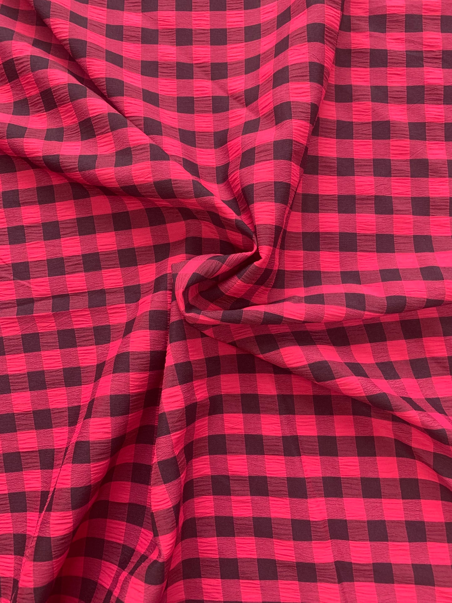 red and black checked fabric is gathered into soft folds