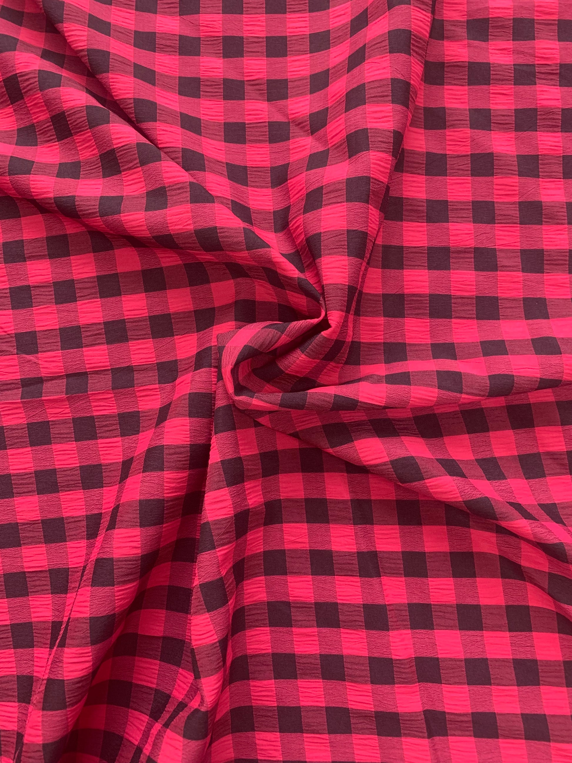 red and black checked fabric is gathered into soft folds