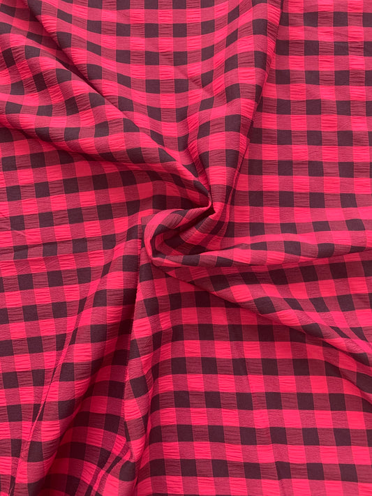 red and black checked fabric is gathered into soft folds