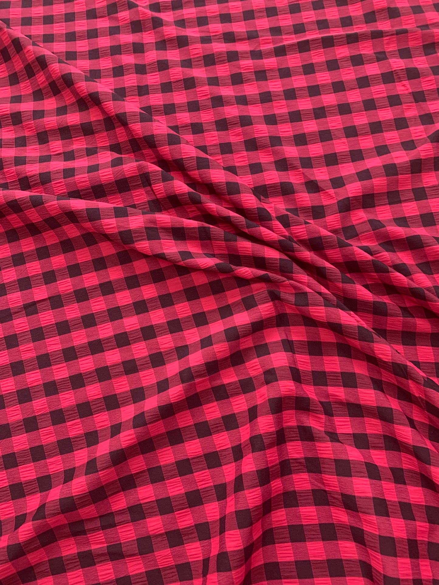 red and yellow gingham fabric is shown in close-up