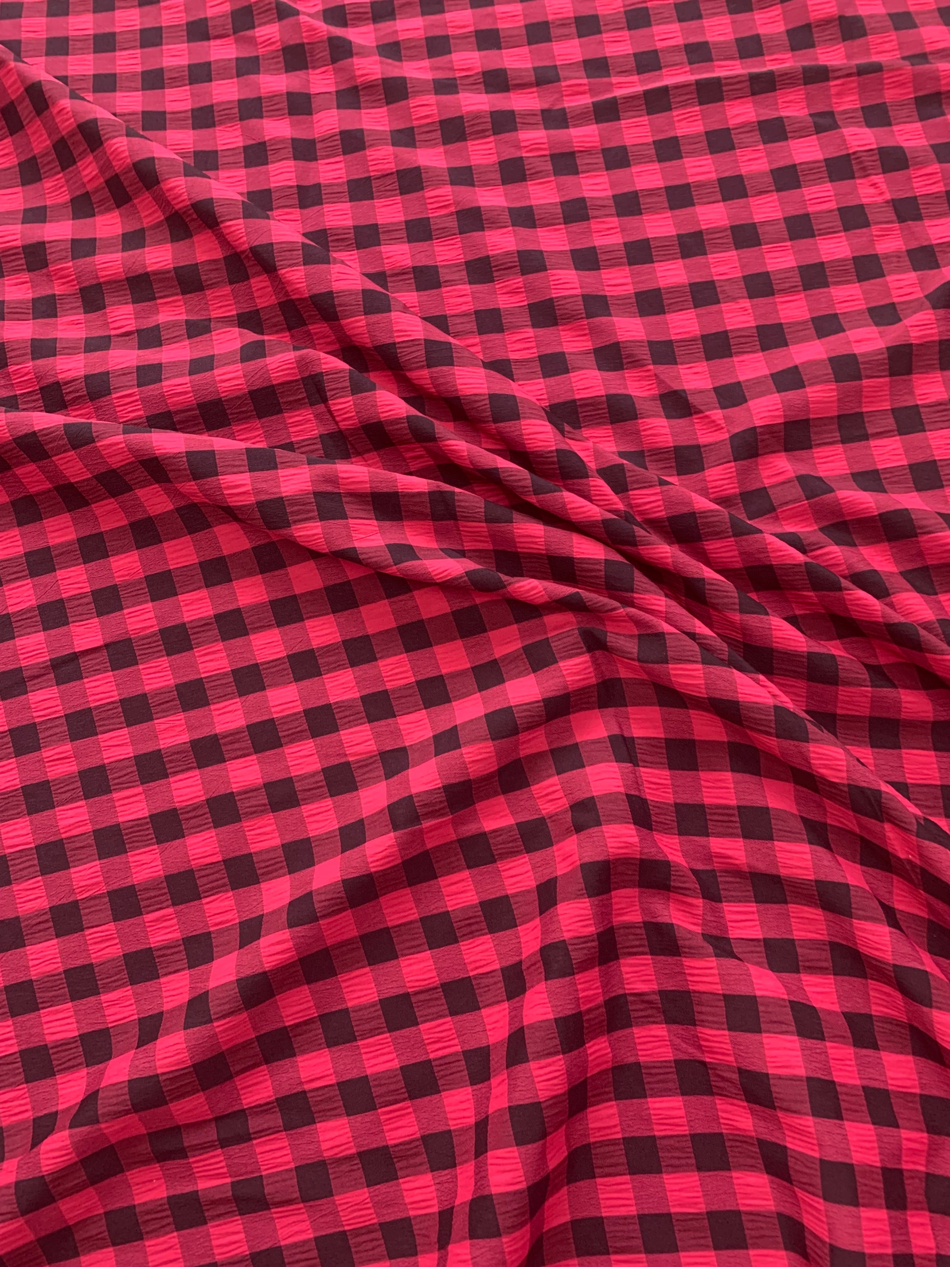 red and yellow gingham fabric is shown in close-up