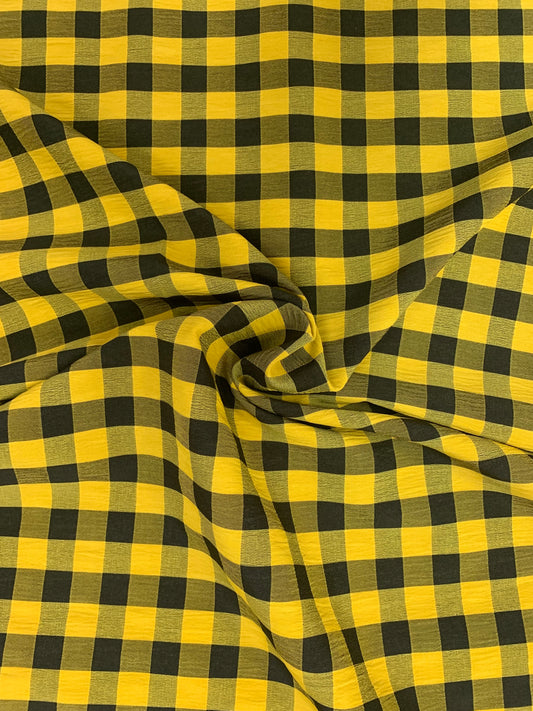 Yellow and black checked fabric is gathered into soft folds