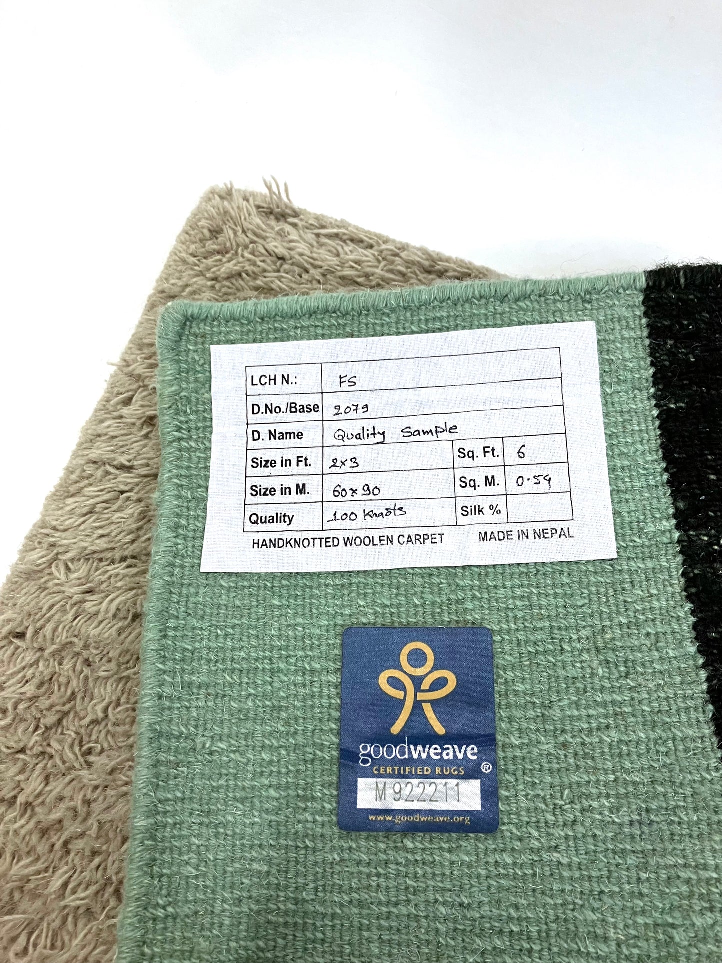 Back of carpet sample is shown with label on a white background.