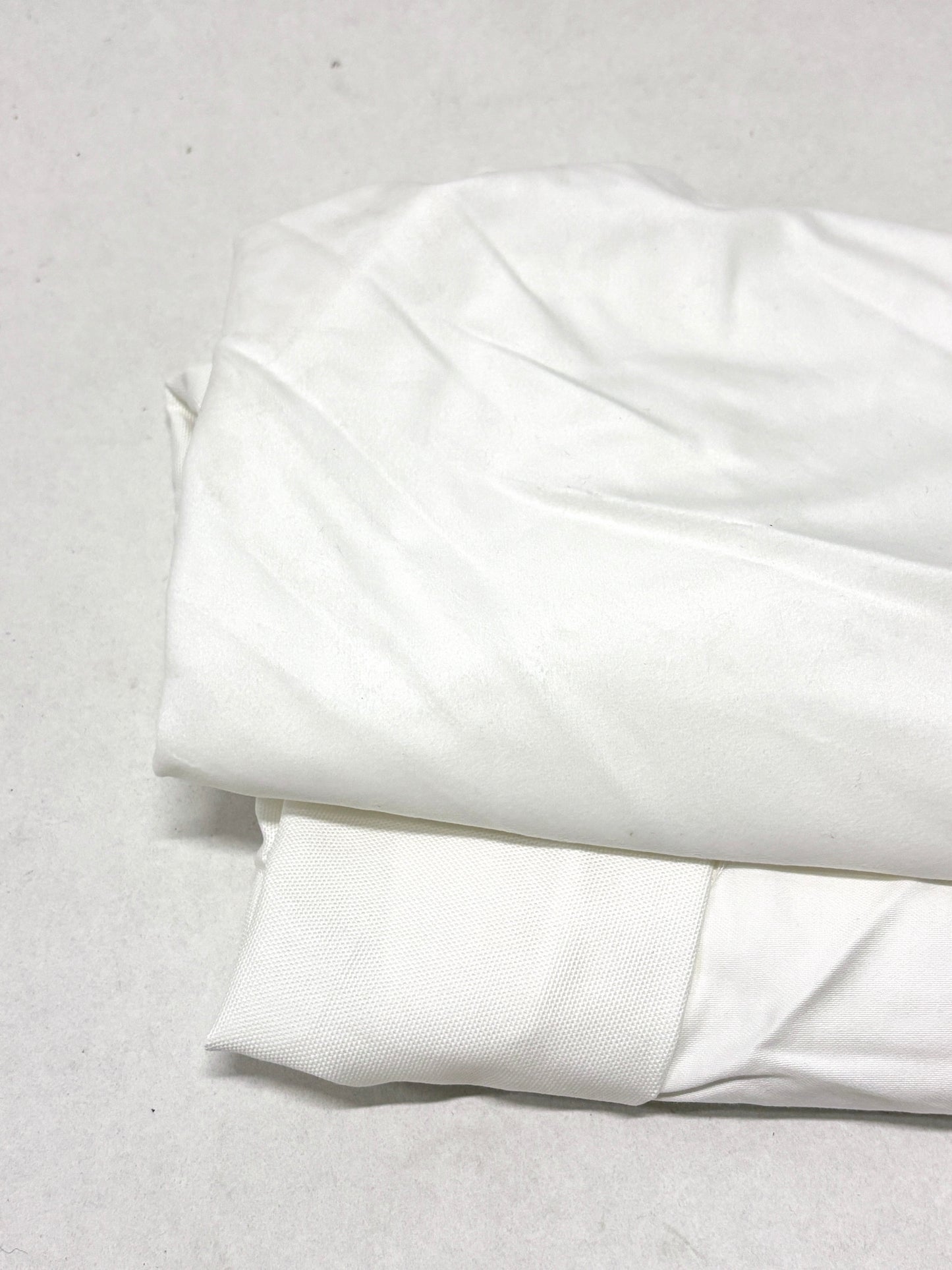 White fabric on a light gray background