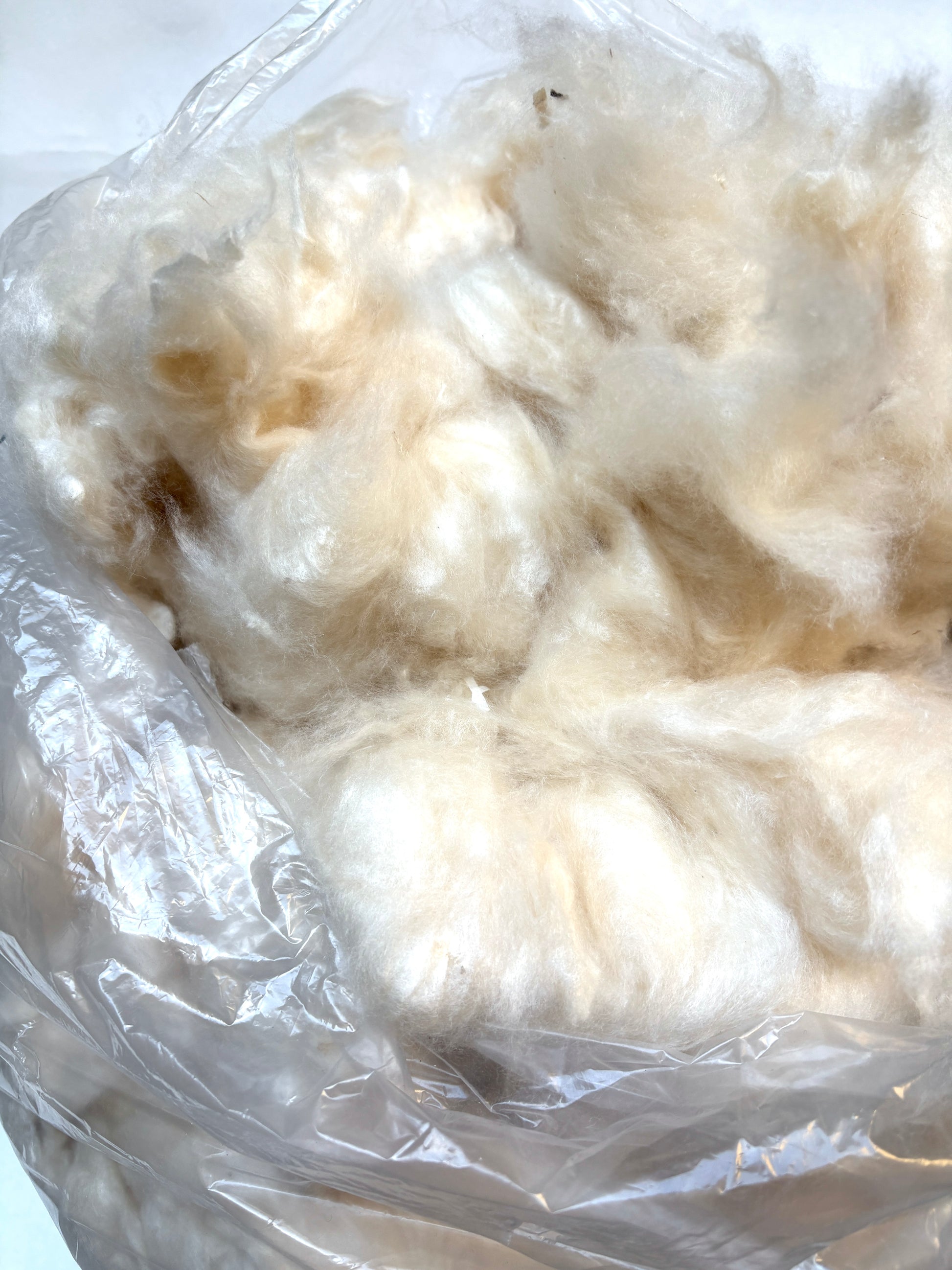 White cotton-like stuffing material in a clear plastic bag