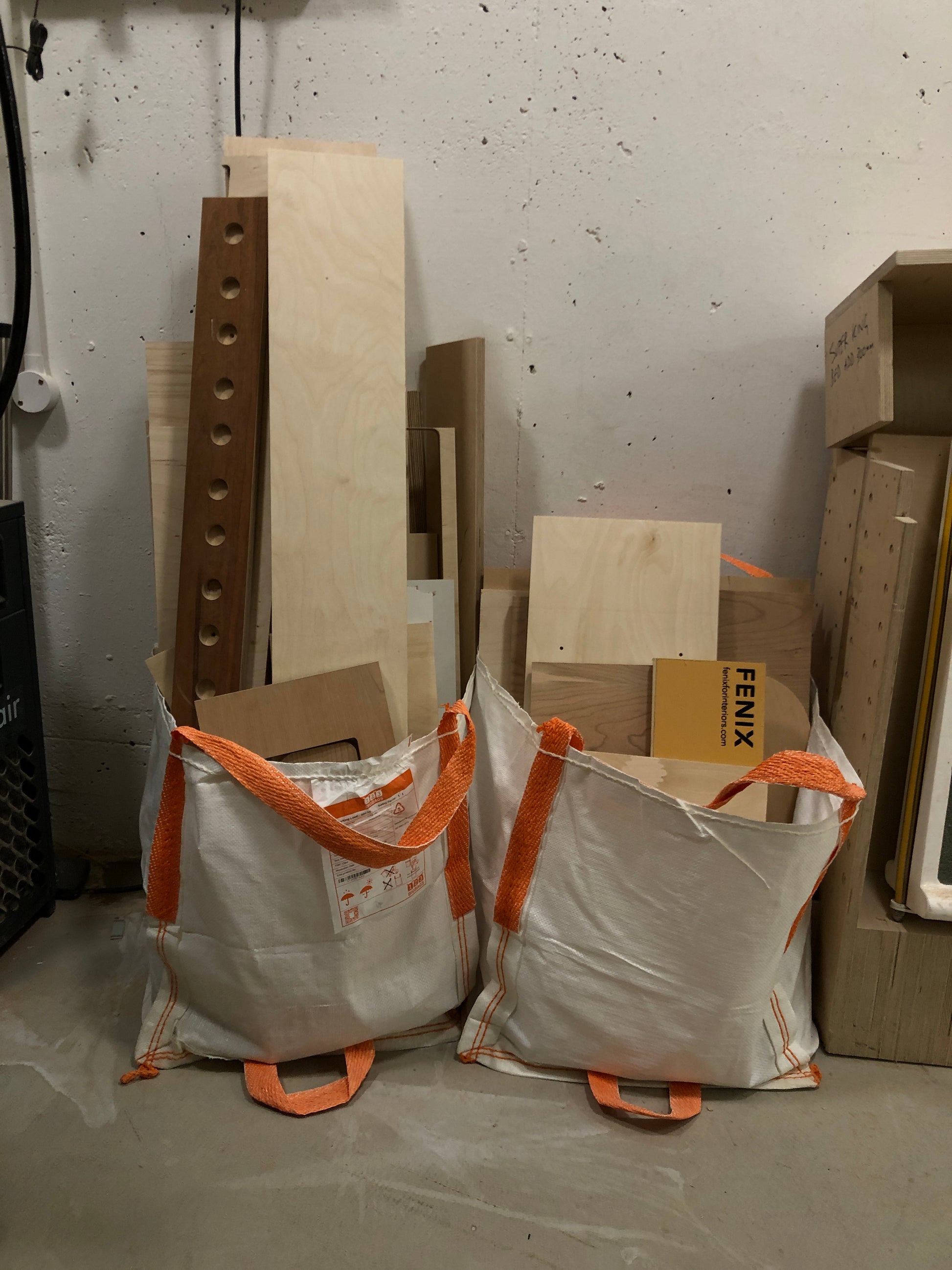 Two bags of a collection of various-sized off-cut plywood
