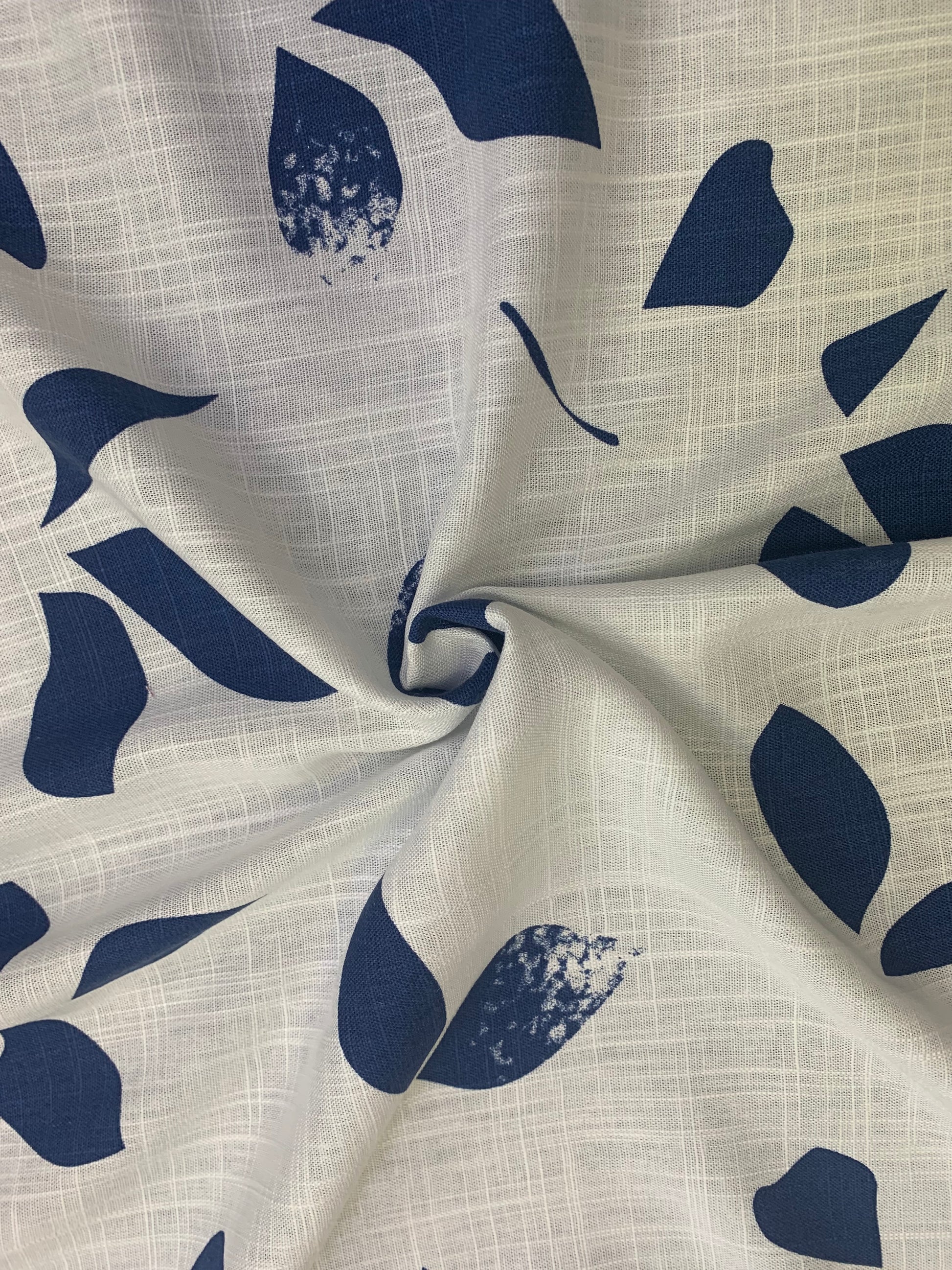 Leaf-patterned fabric is gathered into a small central fold