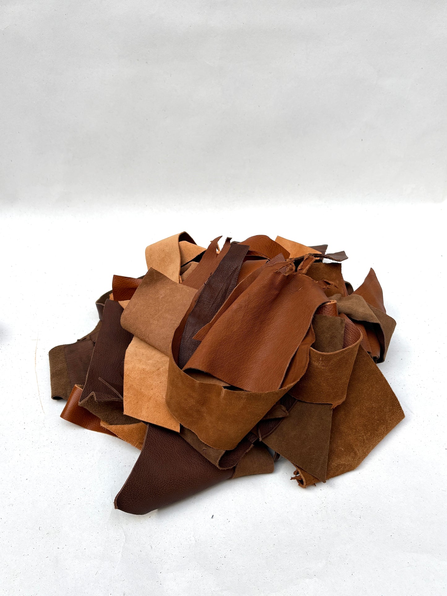 Close-up views show leather pieces in varied brown shades and textures