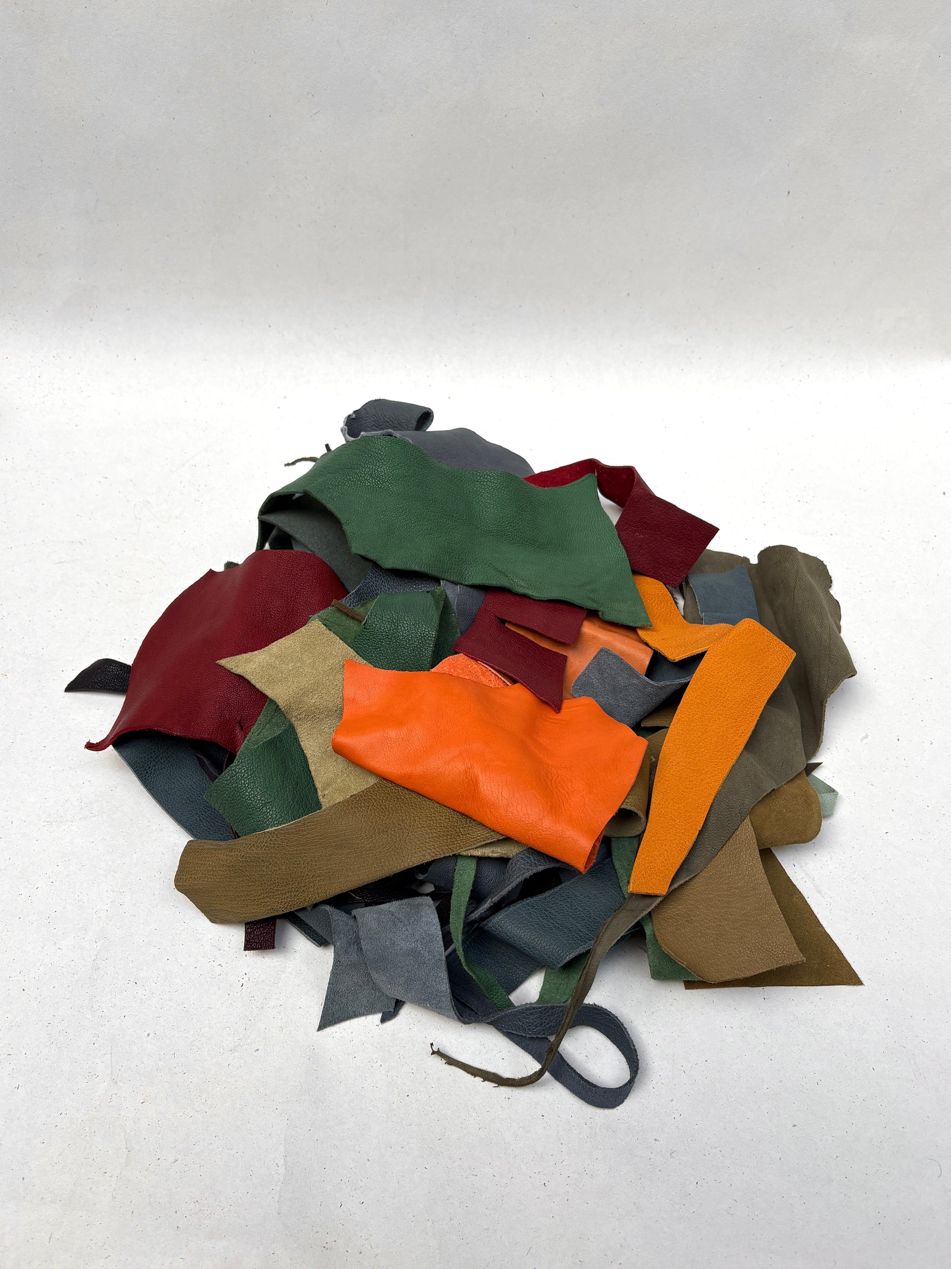 Assorted cut material pieces are shown in a loose layered bundle