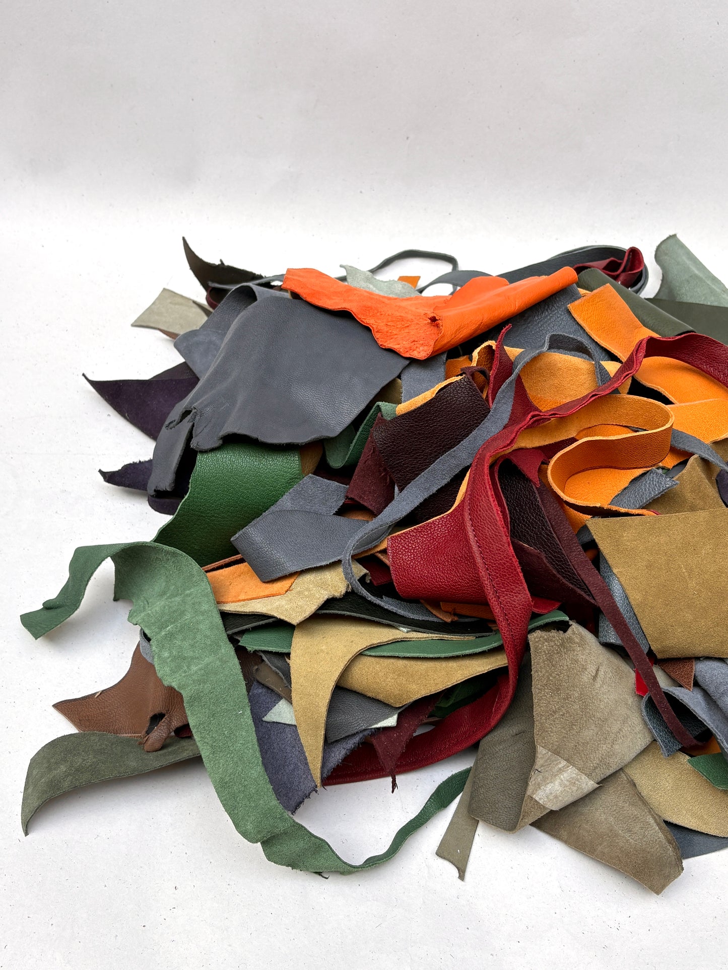 Bright and muted offcuts are shown in a mixed stacked pile