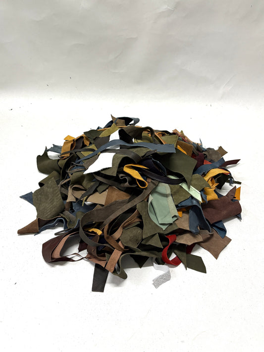 Pile of multicolored leather offcuts on a white background