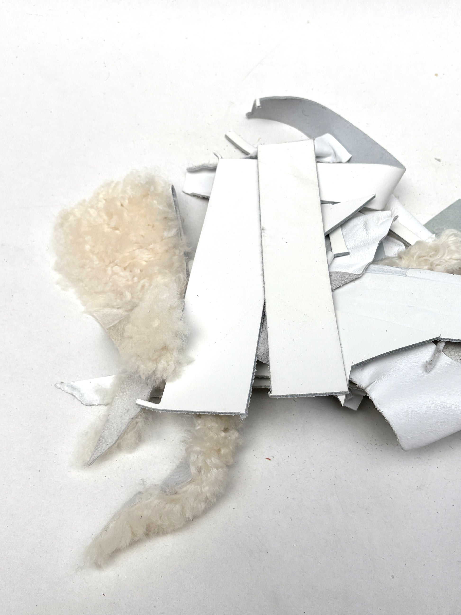 Mixed white scraps and soft fibres are shown in a loose bundle
