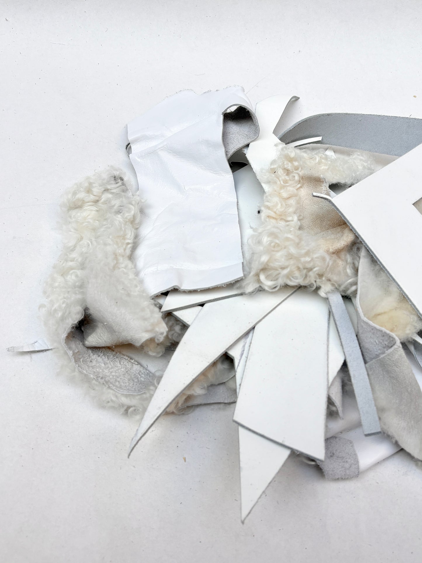 Close-up views show white offcuts in different shapes and textures