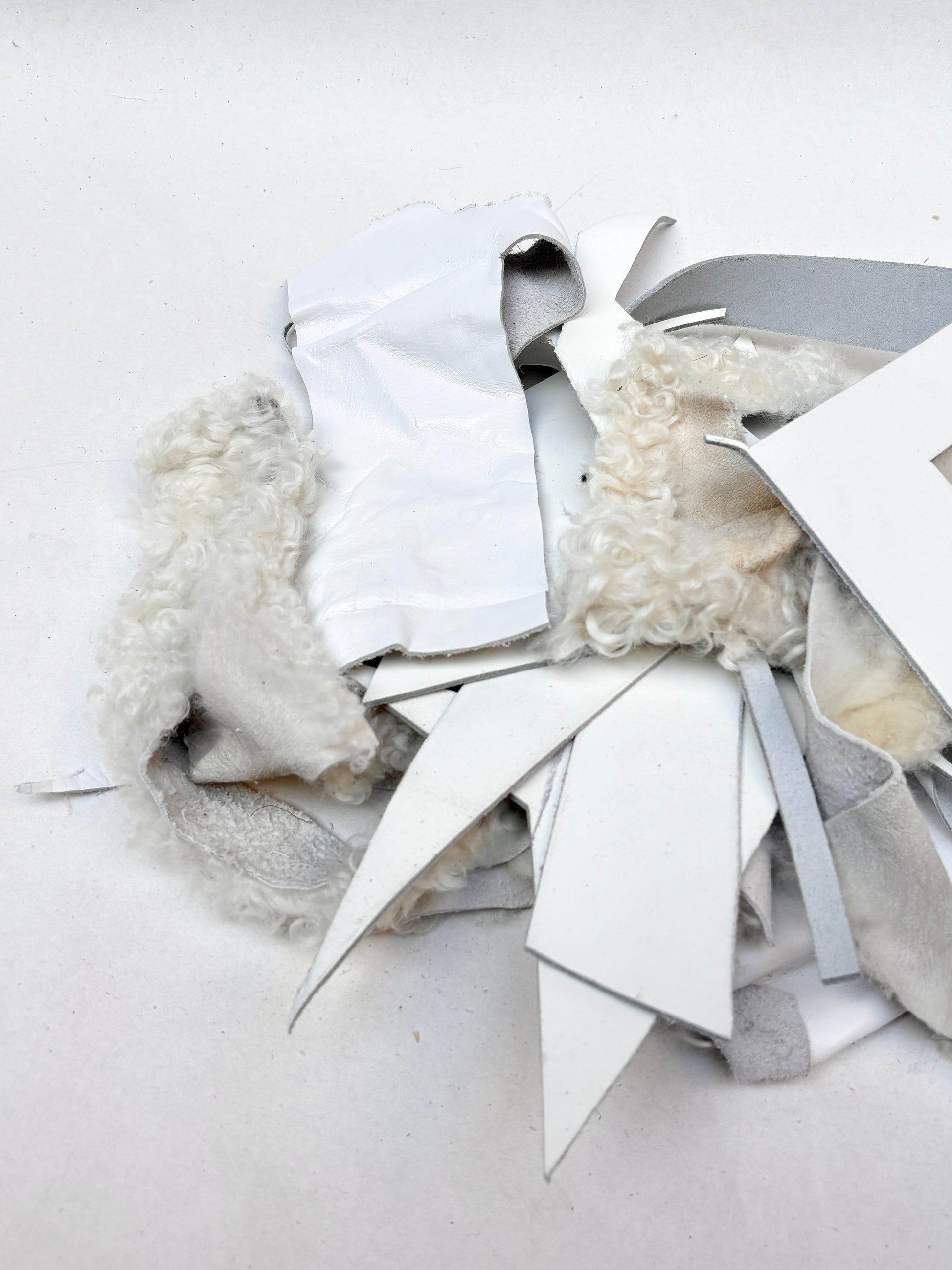 Close-up views show white offcuts in different shapes and textures