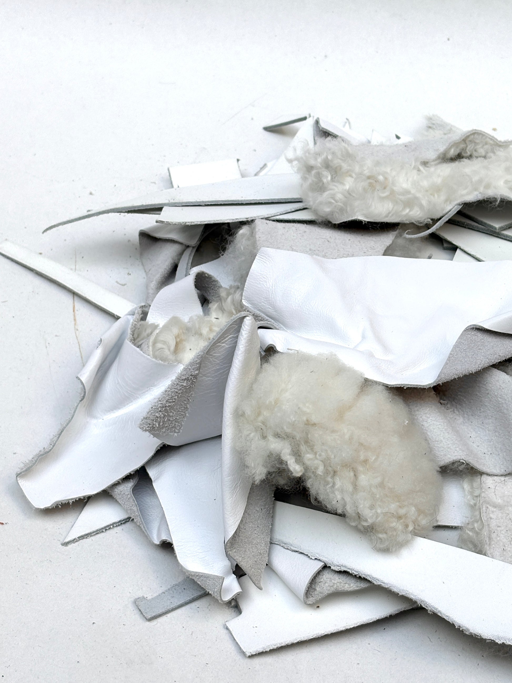 White material pieces are layered together in a small piled stack