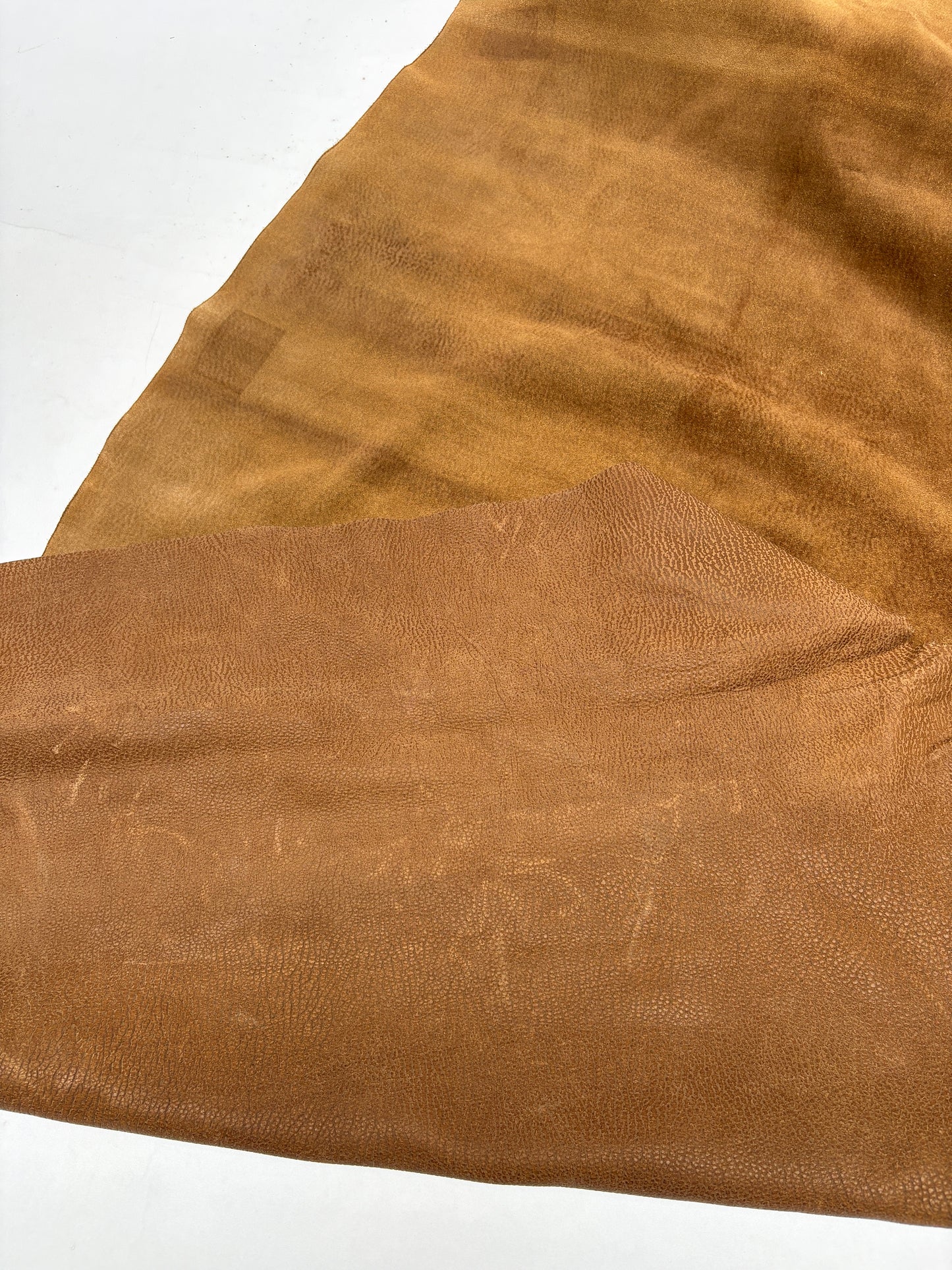 Close-up of light brown leather on a white background