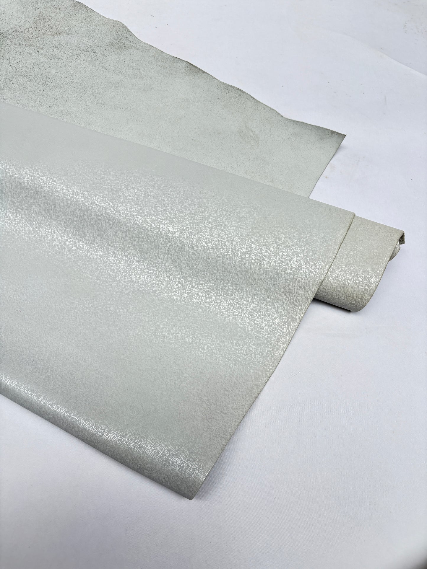 Roll of white leather on a white background