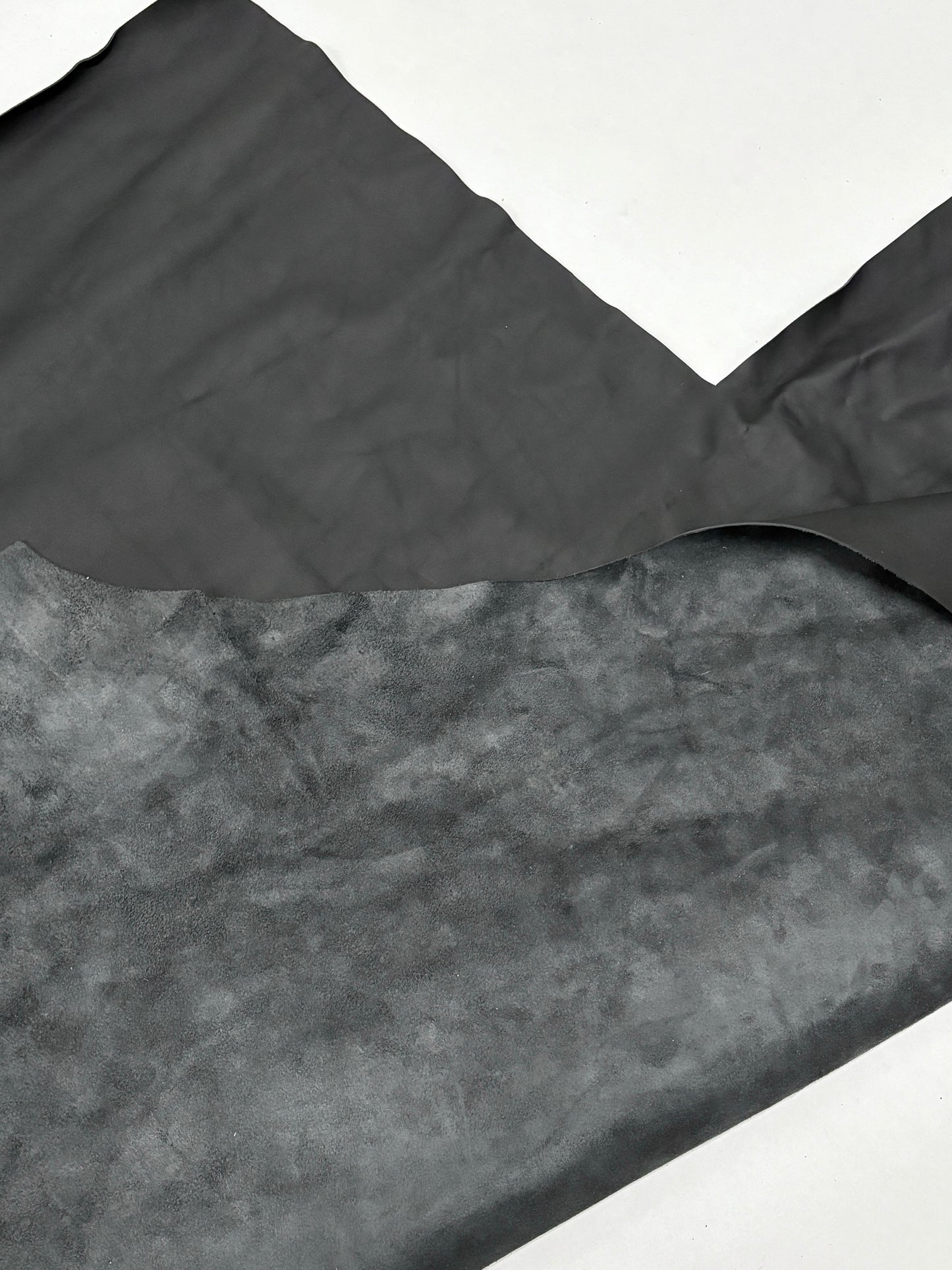 Close-up of foggy black leather on a white background