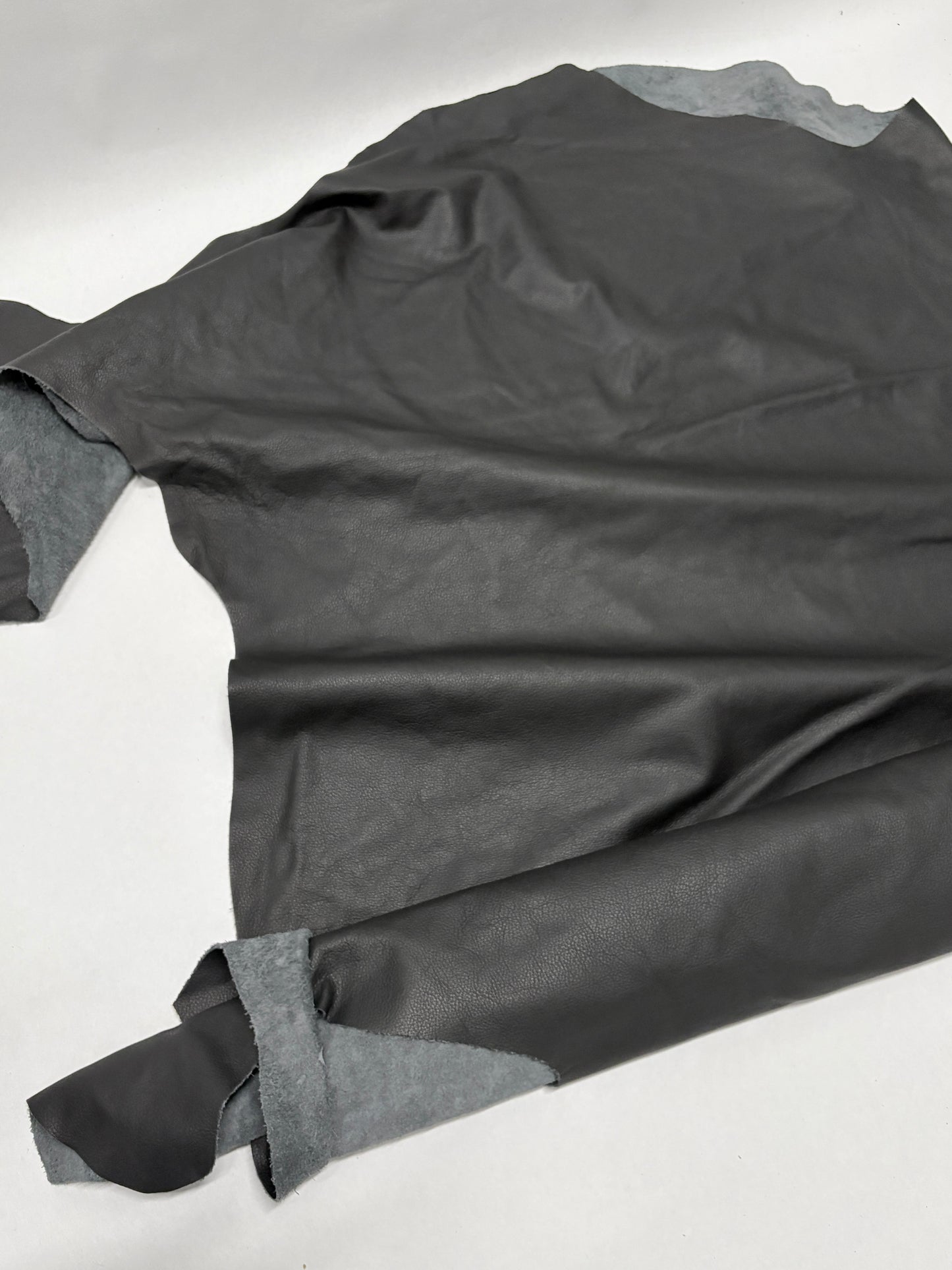 Glossy black leather on a white background