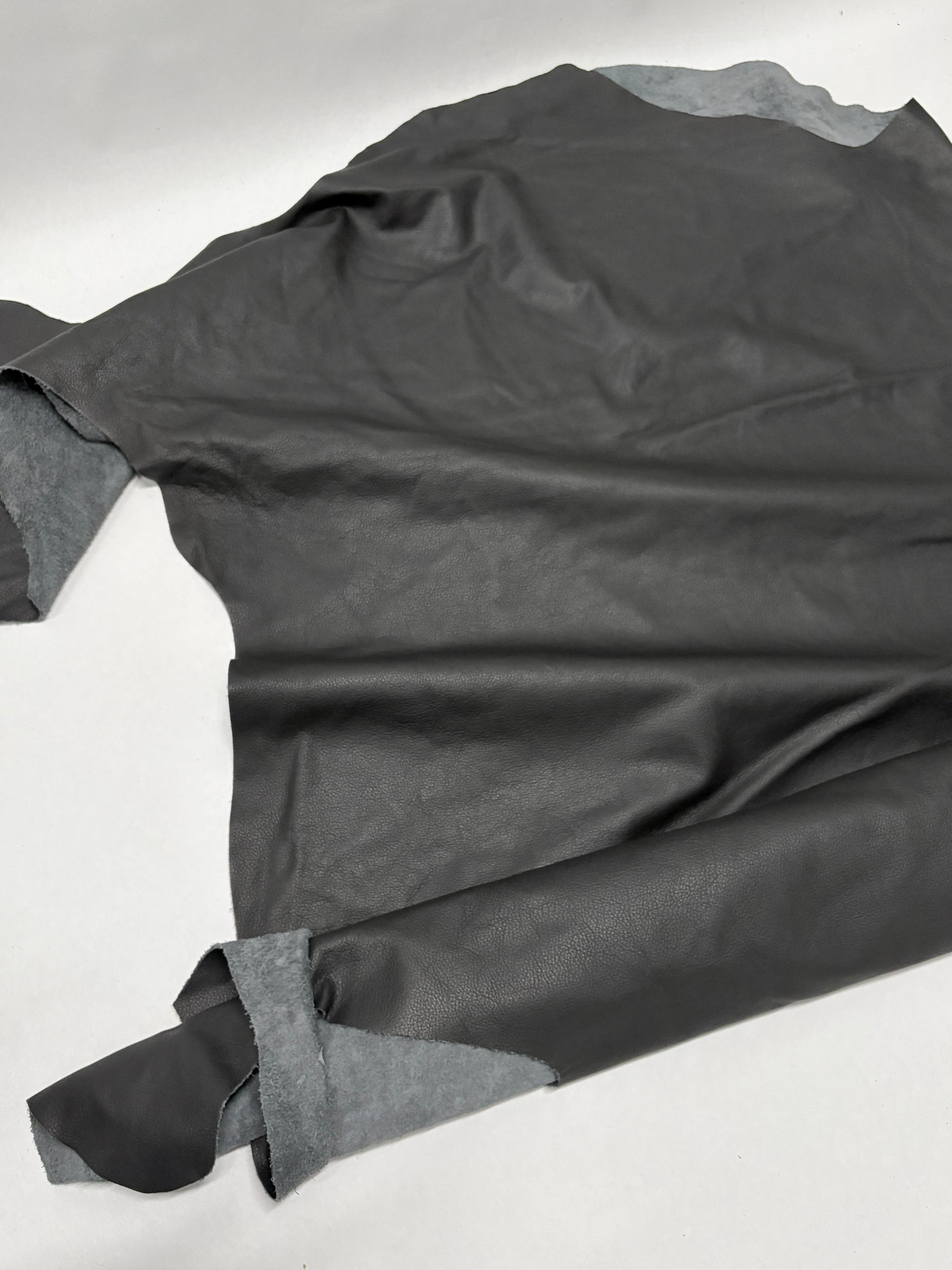 Glossy black leather on a white background