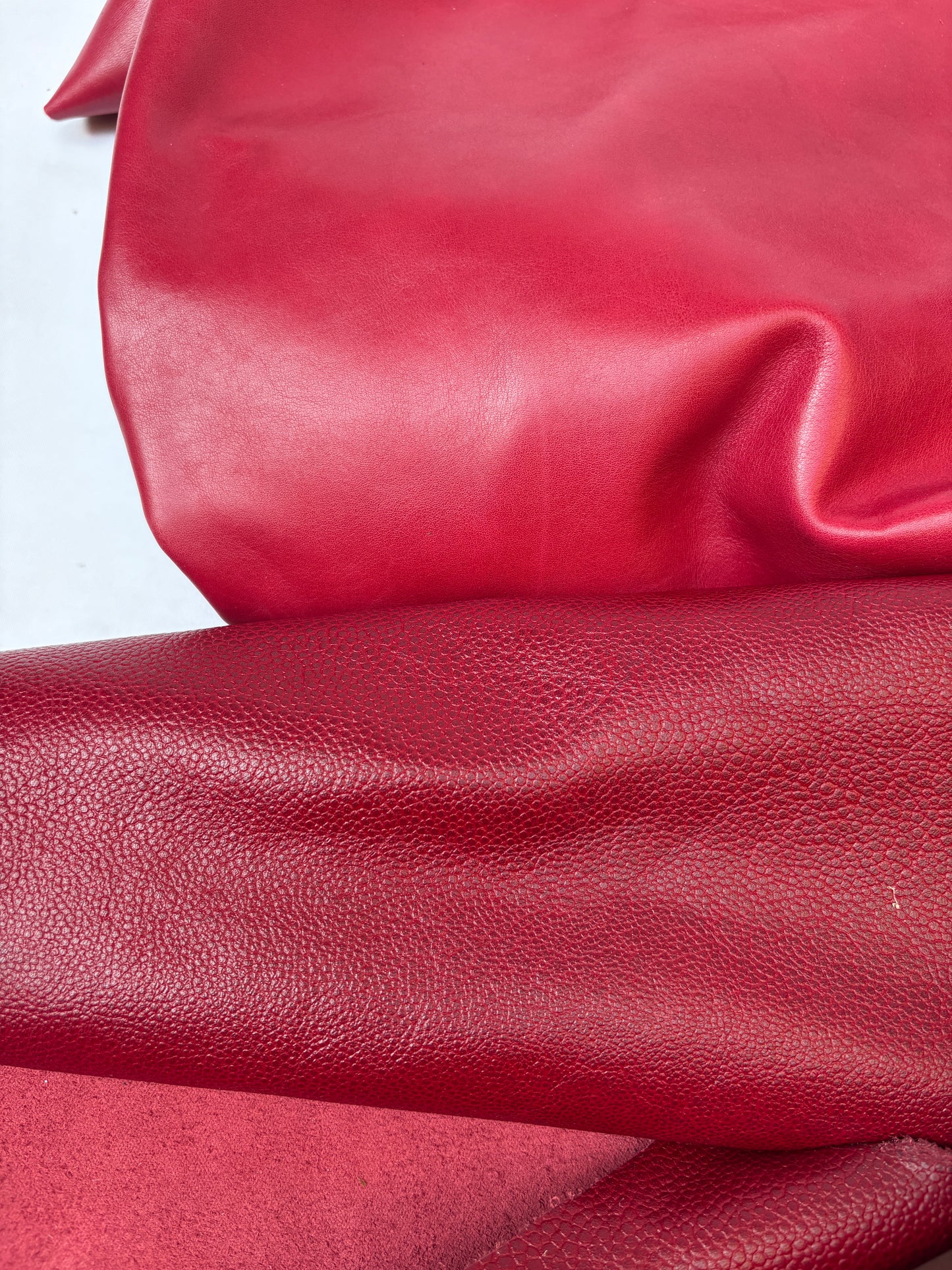 Close-up of red leather with a white background